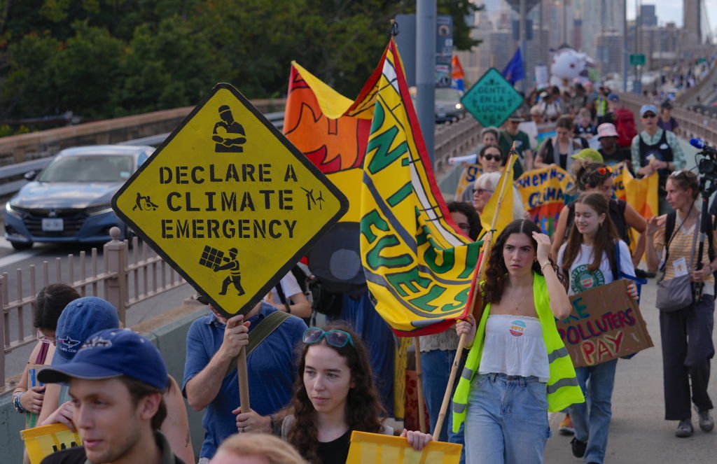 Climate activists march over Brooklyn Bridge to protest fossil fuels in New York City