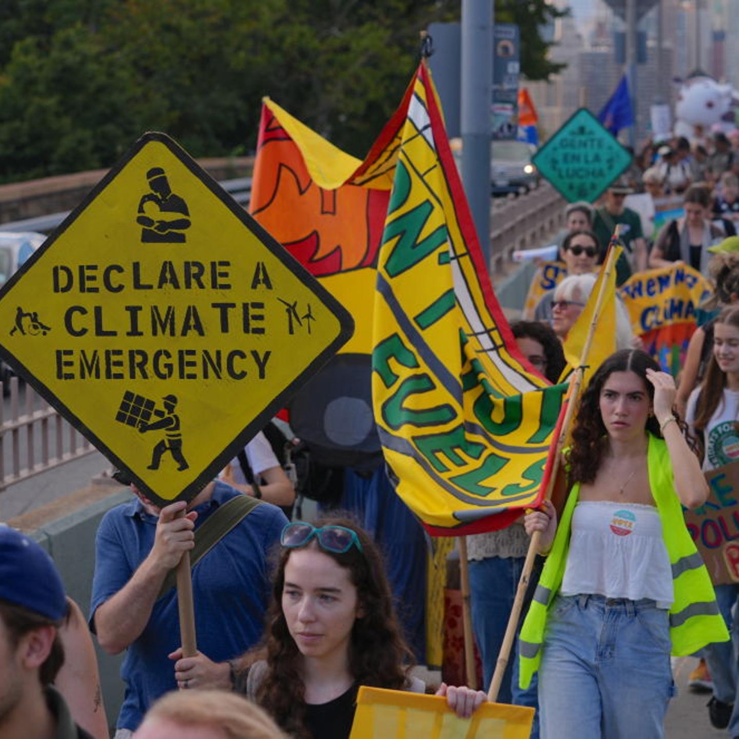 Climate activists march over Brooklyn Bridge to protest fossil fuels in New York City
