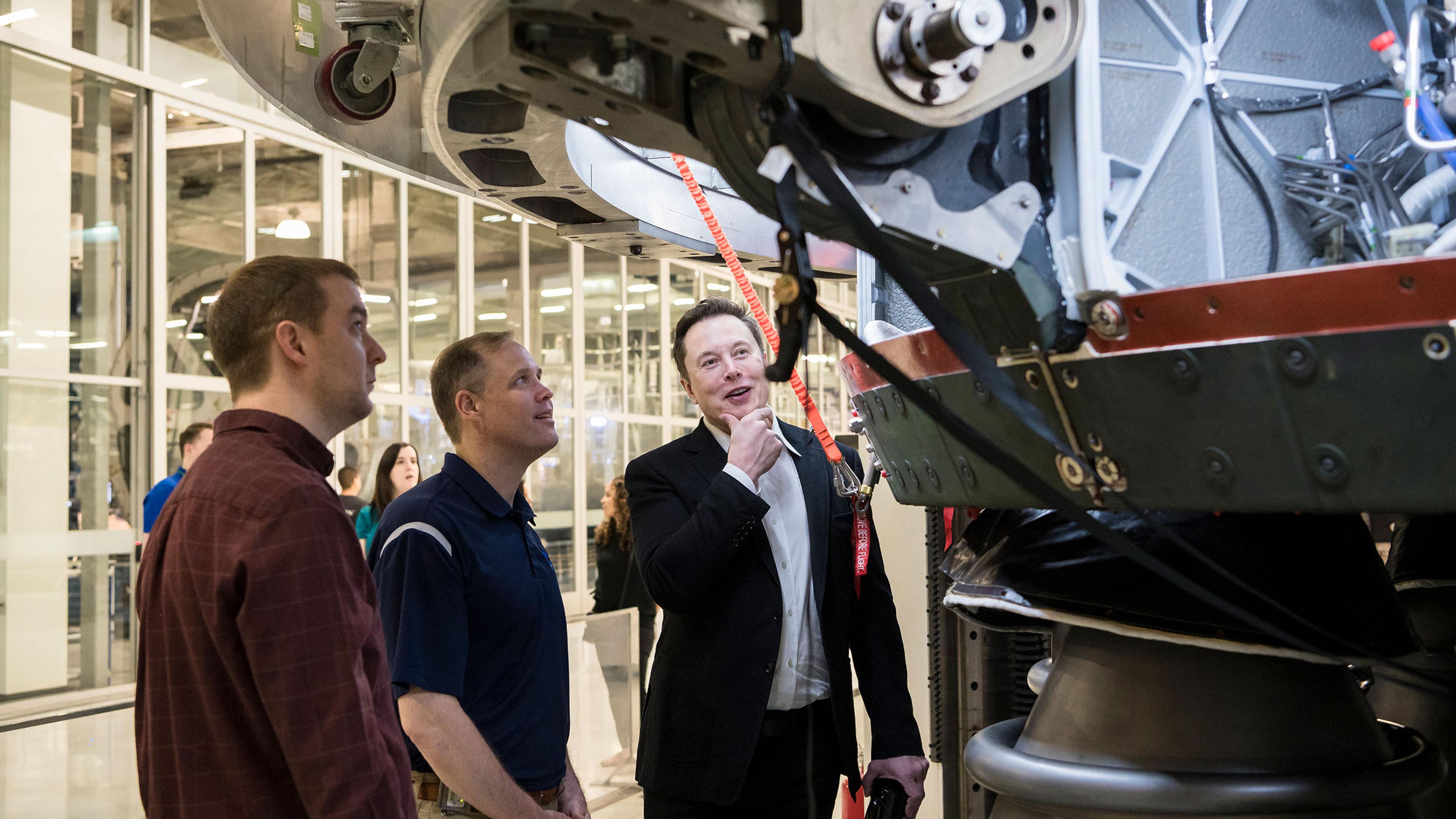 SpaceX Chief Engineer Elon Musk speaks with NASA Administrator Jim Bridenstine while viewing the OctaWeb, part of the Merlin engine used for the Falcon rockets, at the SpaceX Headquarters, in Hawthorne, Calif. on Oct. 10, 2019.
