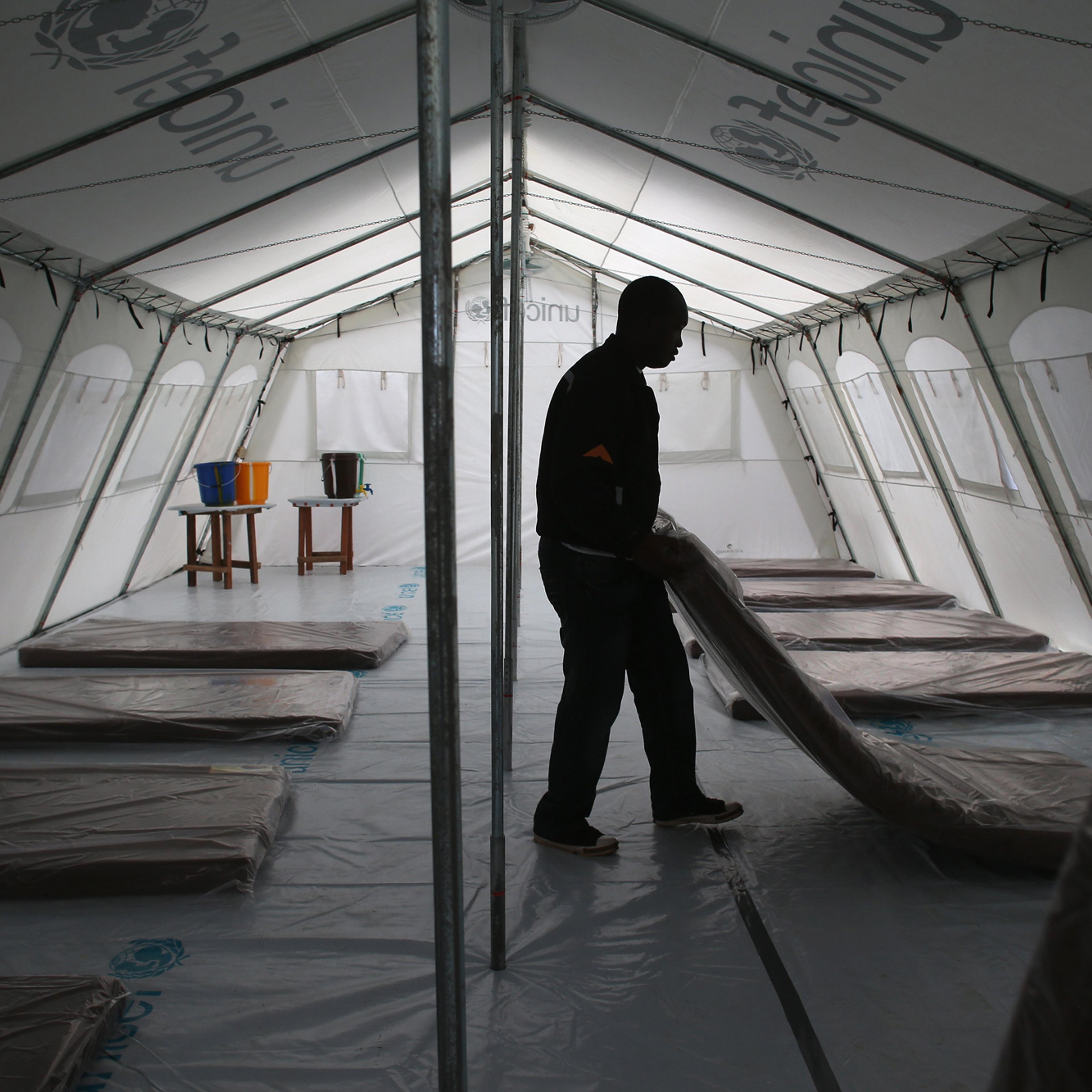 Workers prepare the new Doctors Without Borders (MSF), Ebola treatment center on Aug. 17, 2014 near Monrovia, Liberia. Tents at the center were provided by UNICEF.