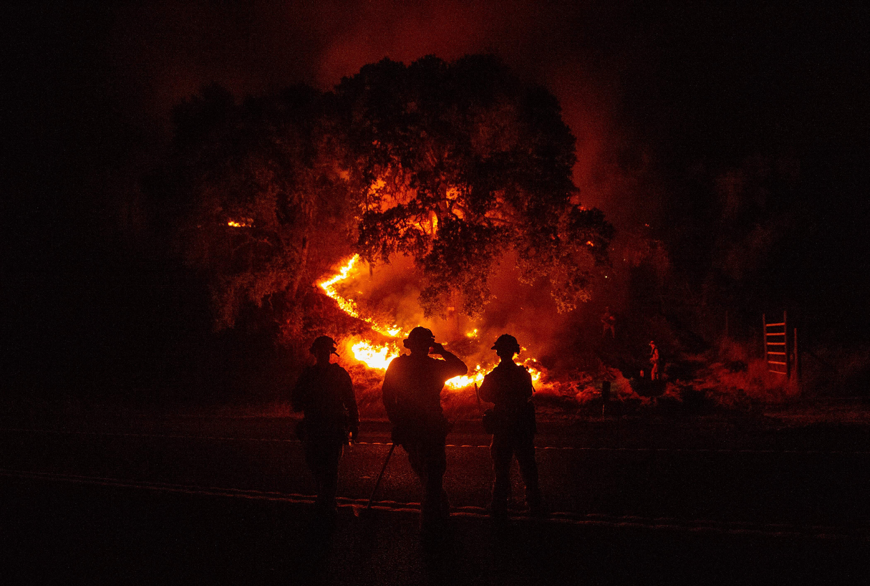 Firefighters watch a back burn during the Mendocino Complex fire in Upper Lake, Calif. on July 31.