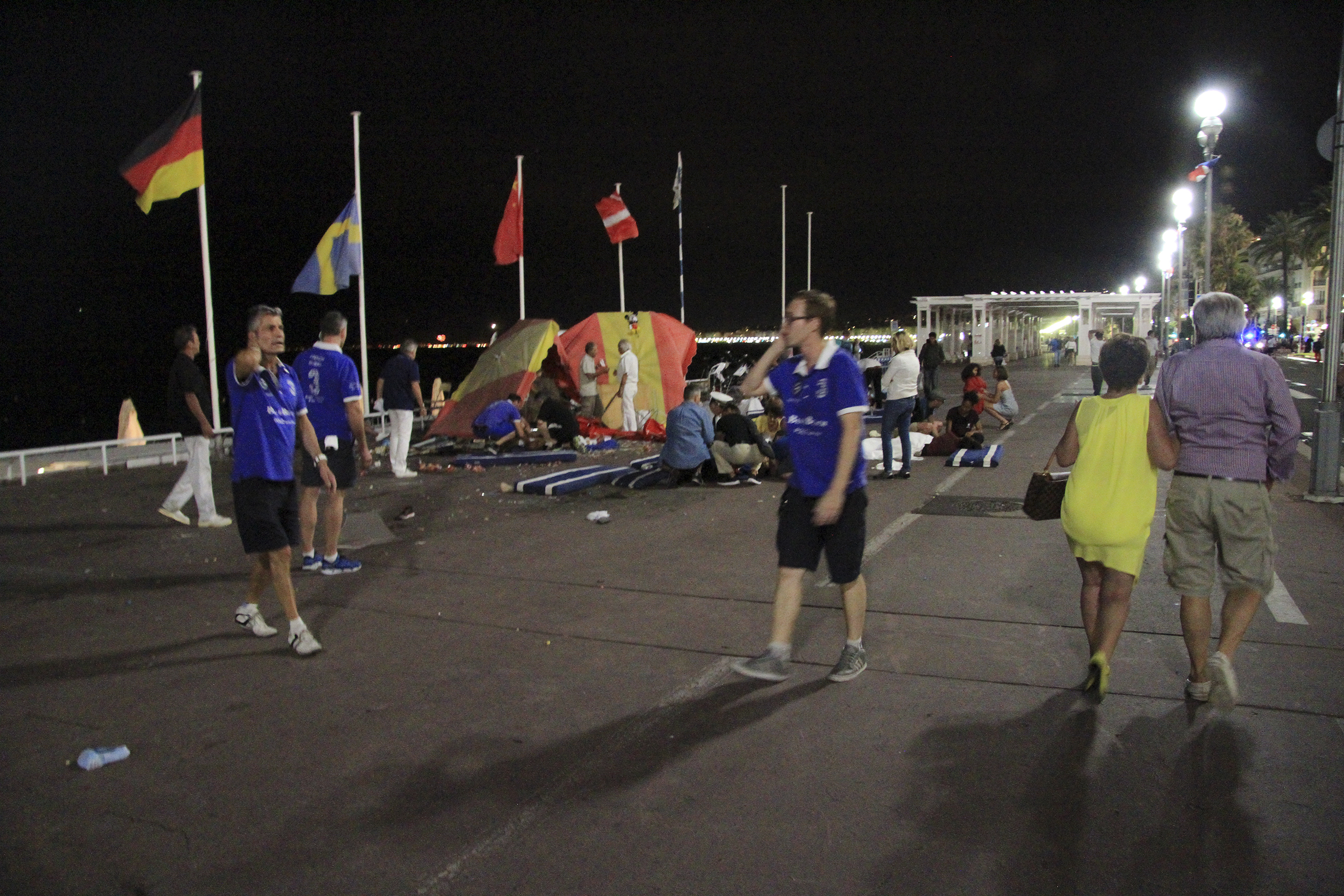 At the site of the terrorist attack, people react along the Promenade des Anglais after a truck crashed into a crowd during celebrations of Bastille Day in Nice, France, July 14, 2016.