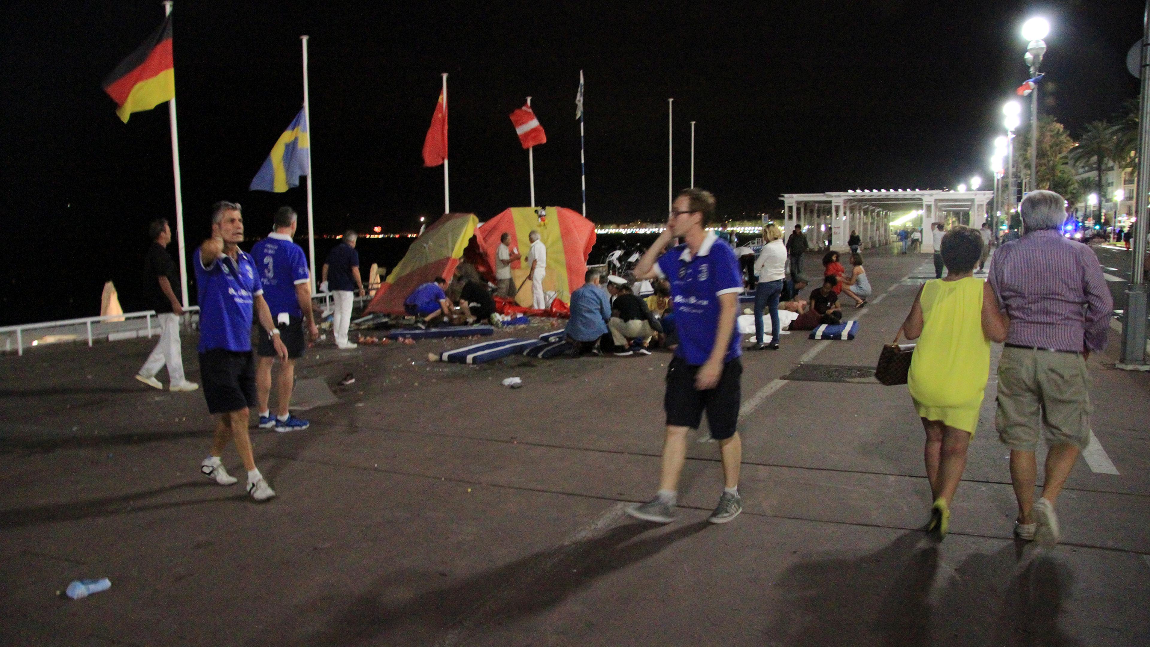 At the site of the terrorist attack, people react along the Promenade des Anglais after a truck crashed into a crowd during celebrations of Bastille Day in Nice, France, July 14, 2016.