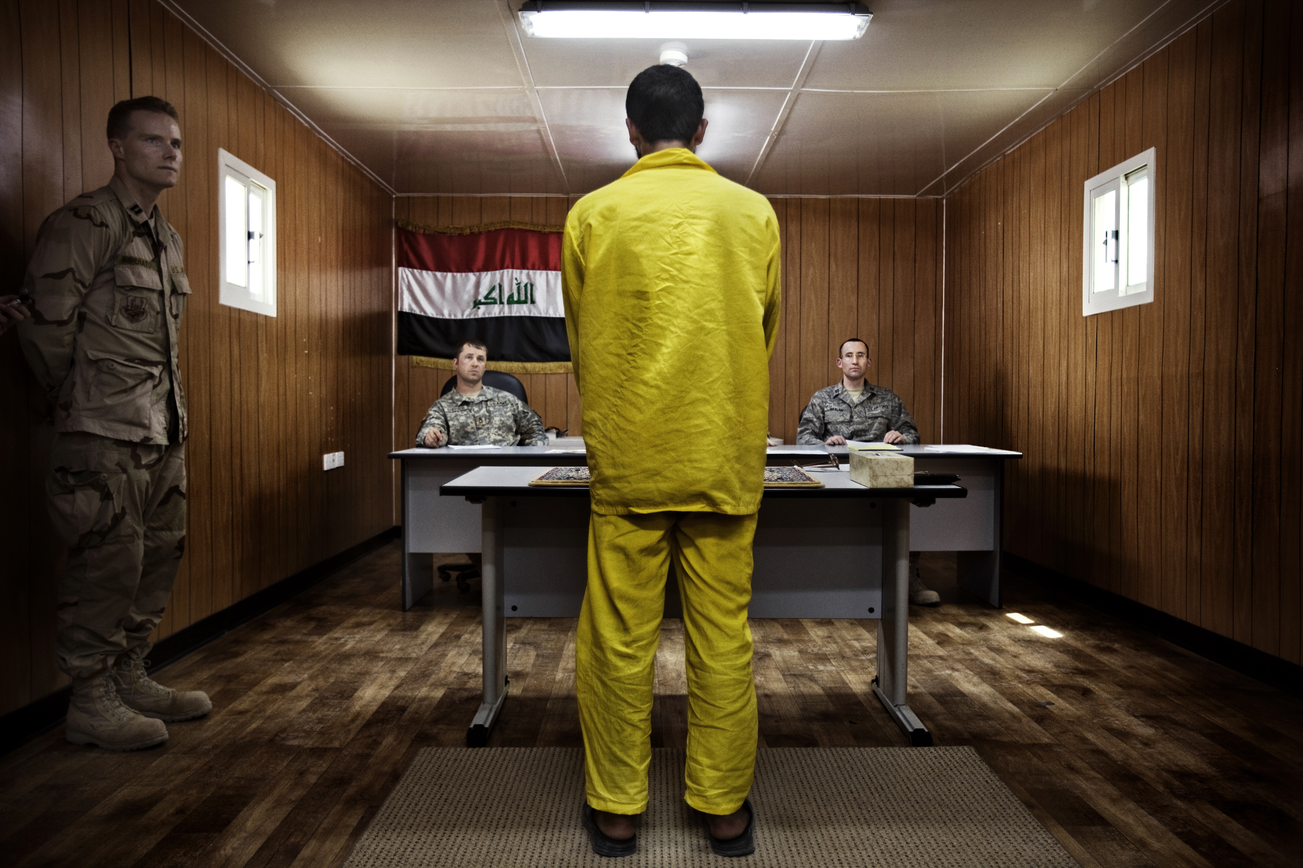 A panel of three American military officers question an Iraqi detainee at Camp Cropper, a U.S. military detention facility in Baghdad, July, 26, 2008. Just under 21,000 Iraqis were held by the U.S. military, outside of the Iraqi justice system, under ter