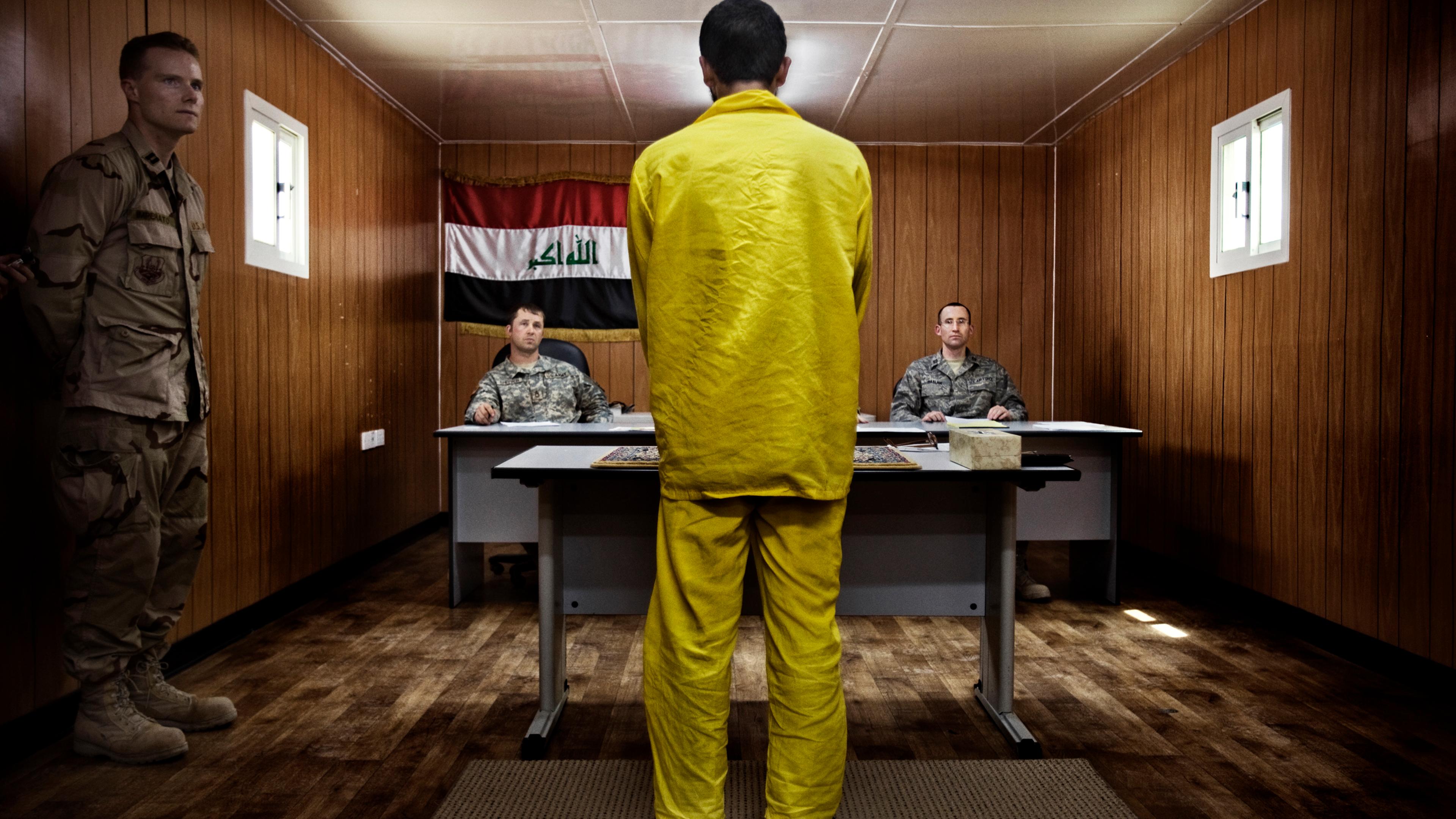 A panel of three American military officers question an Iraqi detainee at Camp Cropper, a U.S. military detention facility in Baghdad, July, 26, 2008. Just under 21,000 Iraqis were held by the U.S. military, outside of the Iraqi justice system, under ter