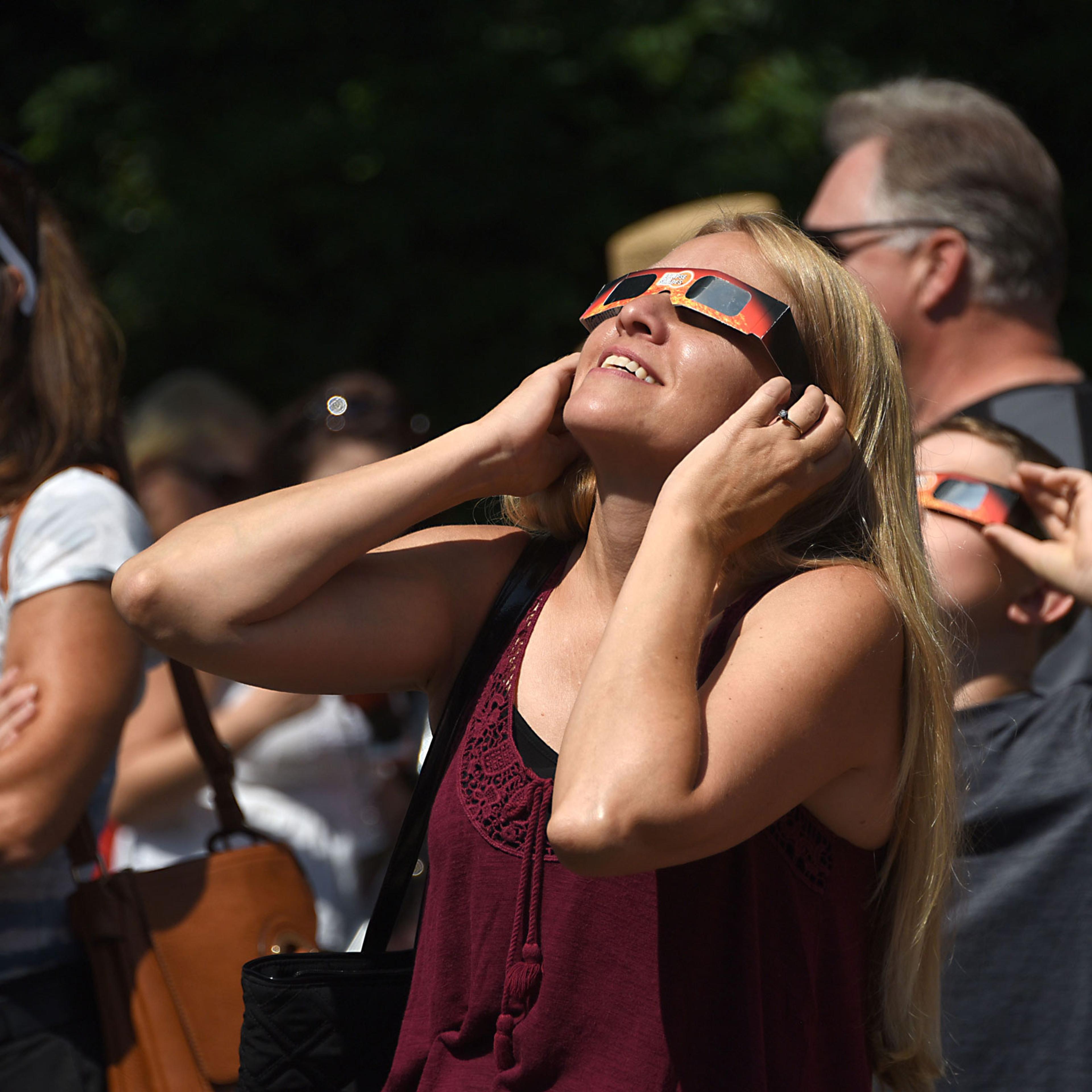 People use special eclipse glasses to watch the solar eclipse, on Aug. 21, 2017 in Schenectady, N.Y.