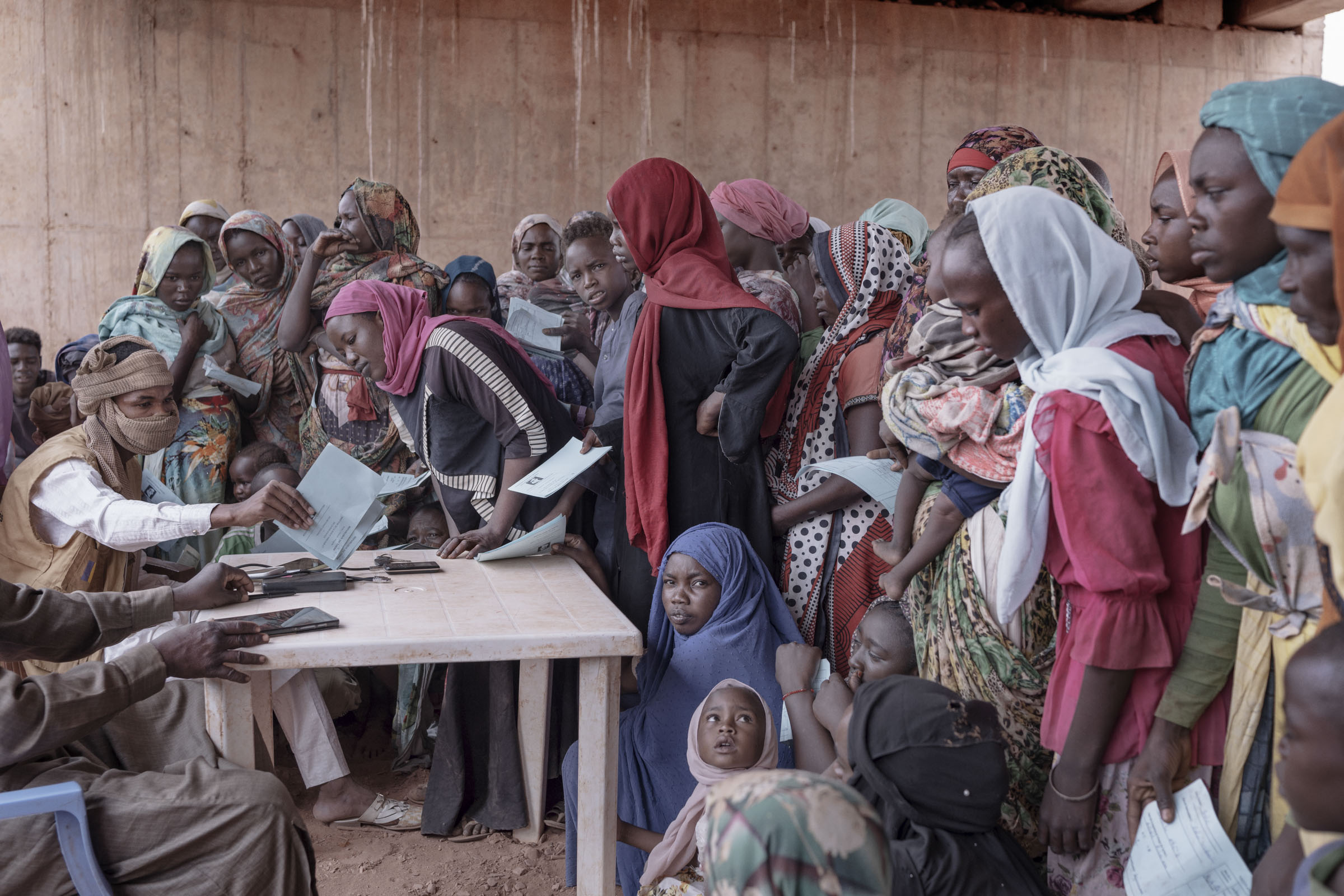 Sudanese women and children register with Chadian authorities upon arrival in Adre, a border town in the Ouaddaï province. According to UNHCR, the conflict in Sudan has forced over 600,000 refugees and 180,000 Chadian returnees since April 2023. Most of 