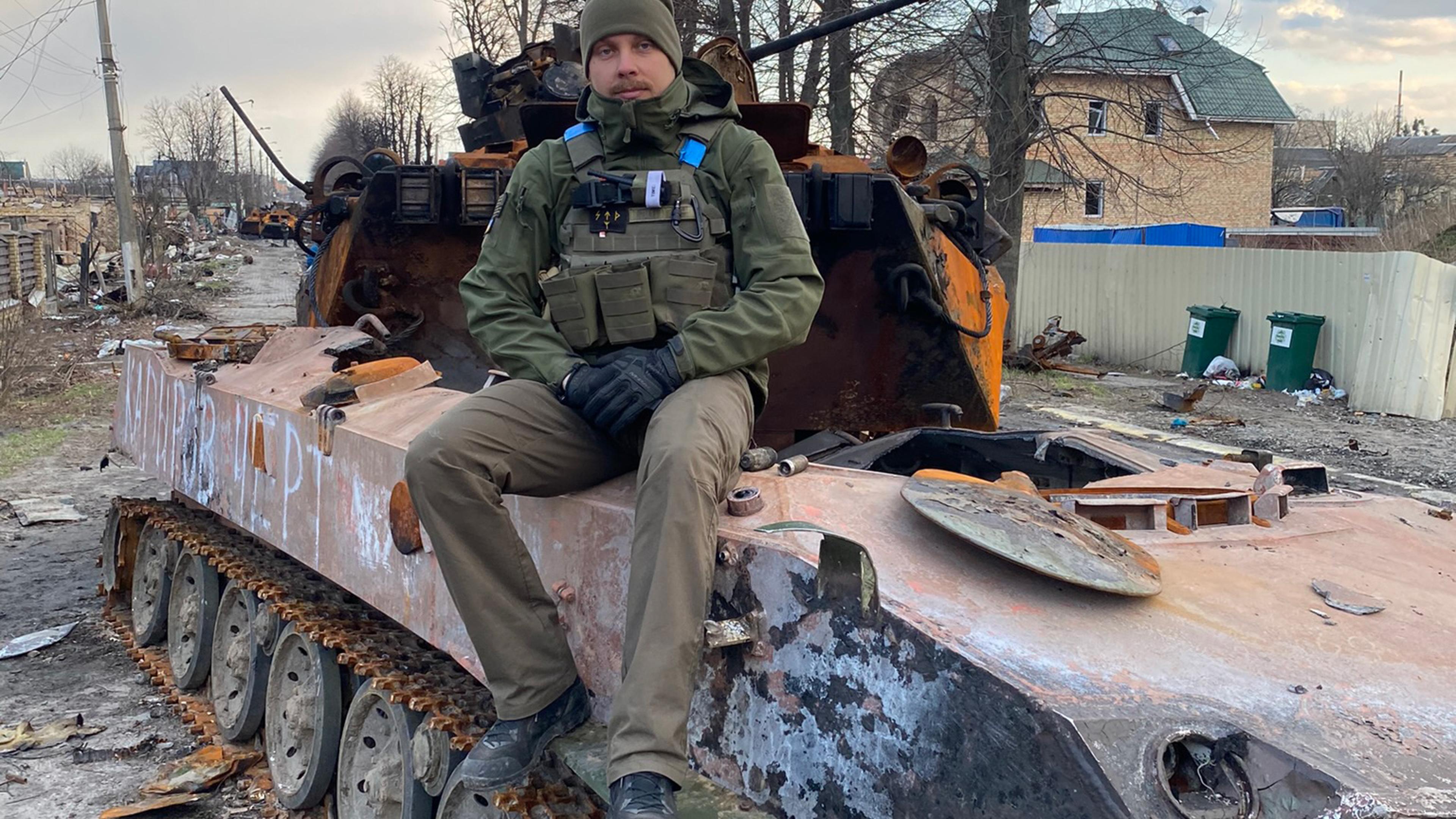 Povilas Limontas sitting on a tank in Bucha on April 4, 2022.