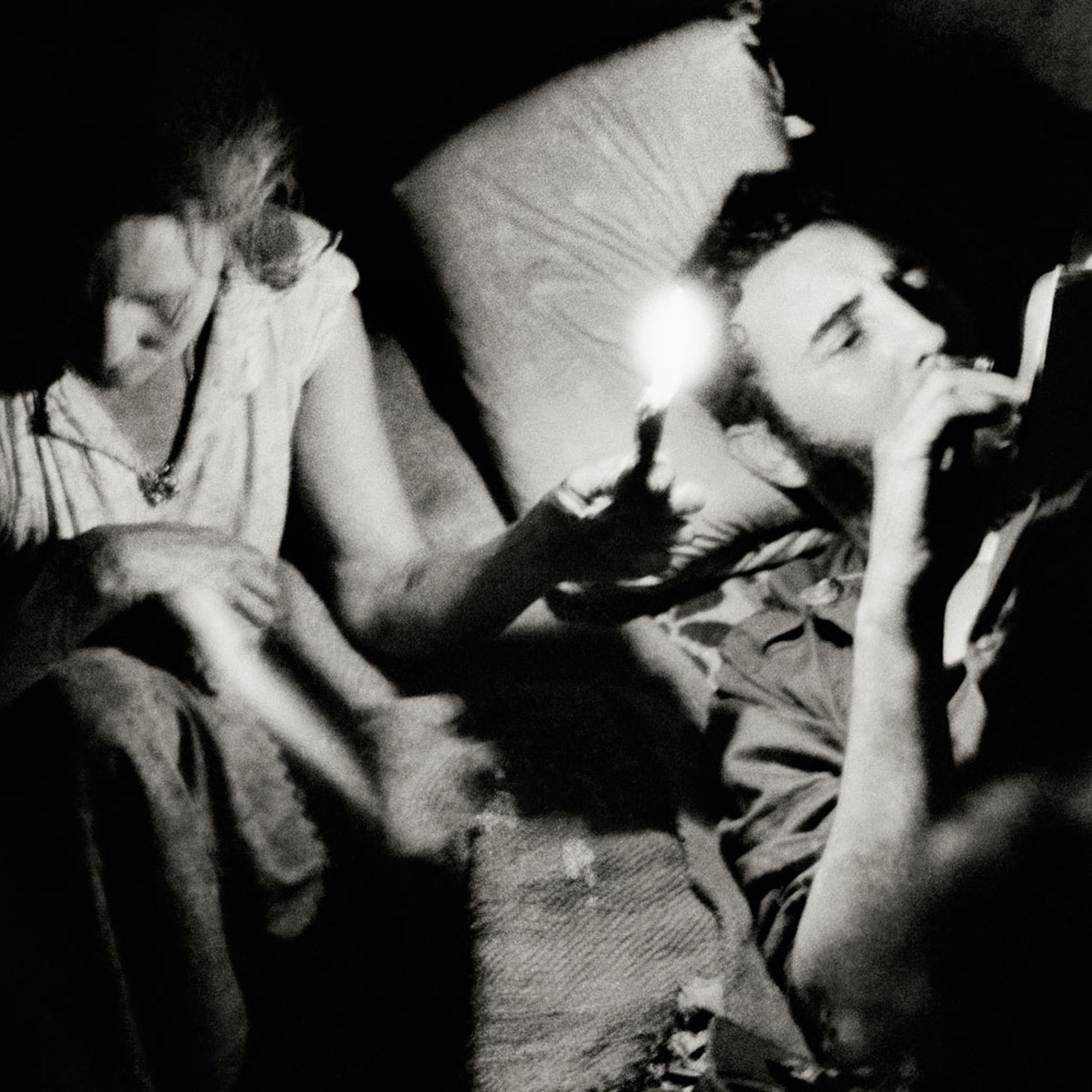 Fidel Castro reads at night during the Battle of Pino del Agua, in the Sierra Maestra mountains, Cuba, 1958.