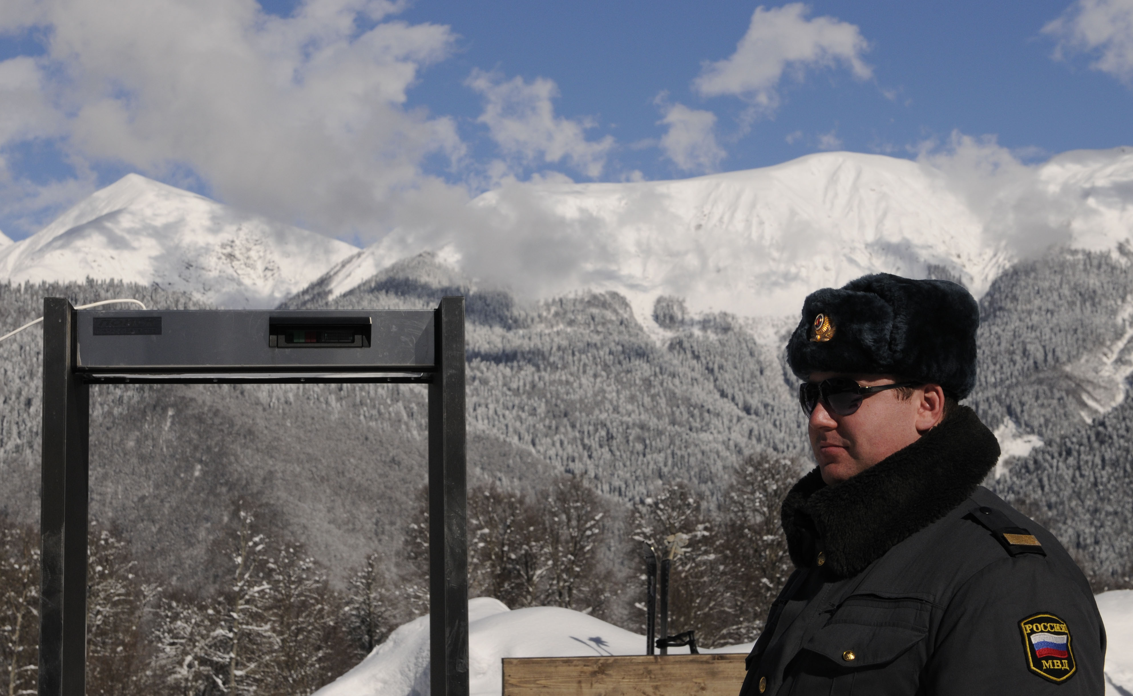 A police officer stands near a metal det