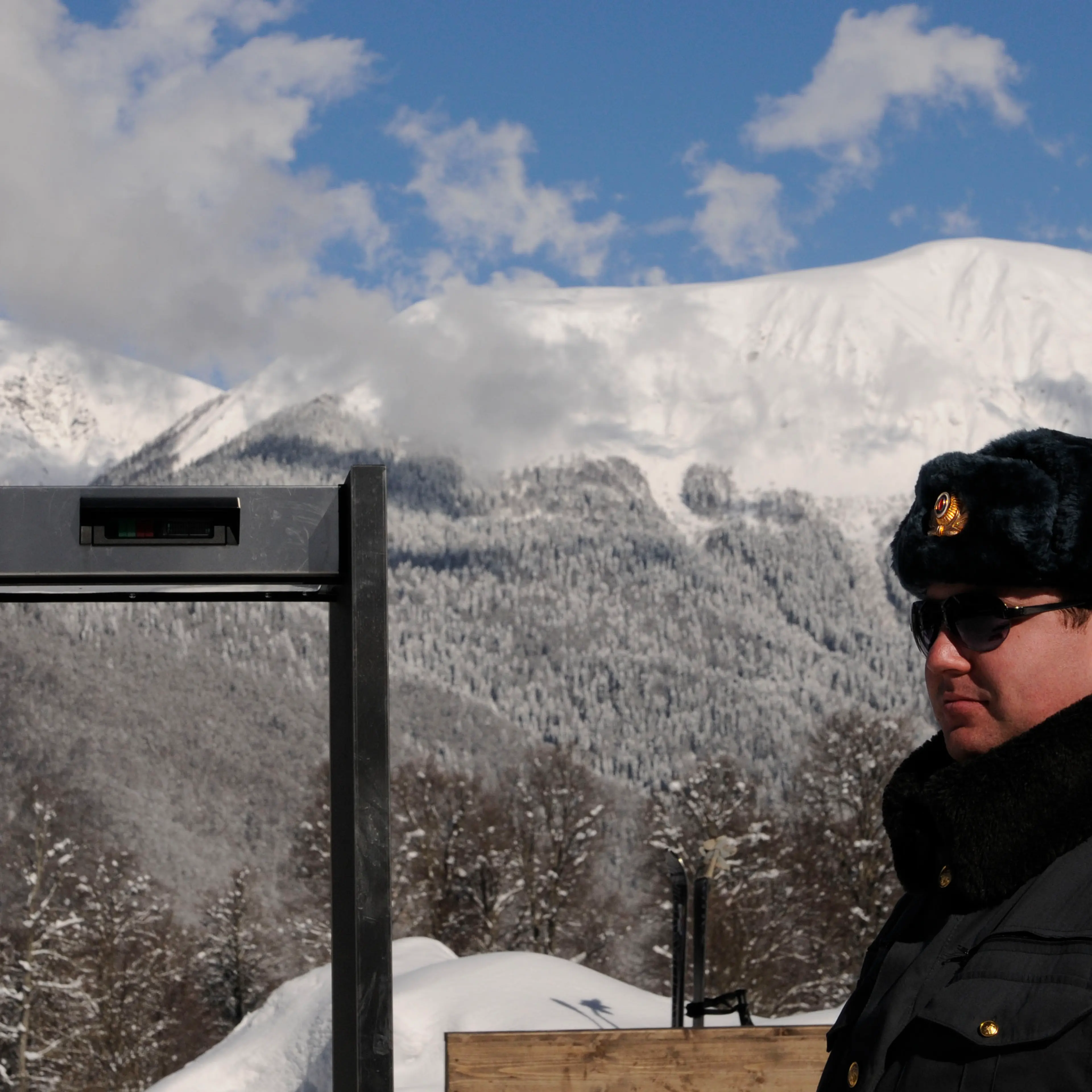 A police officer stands near a metal det
