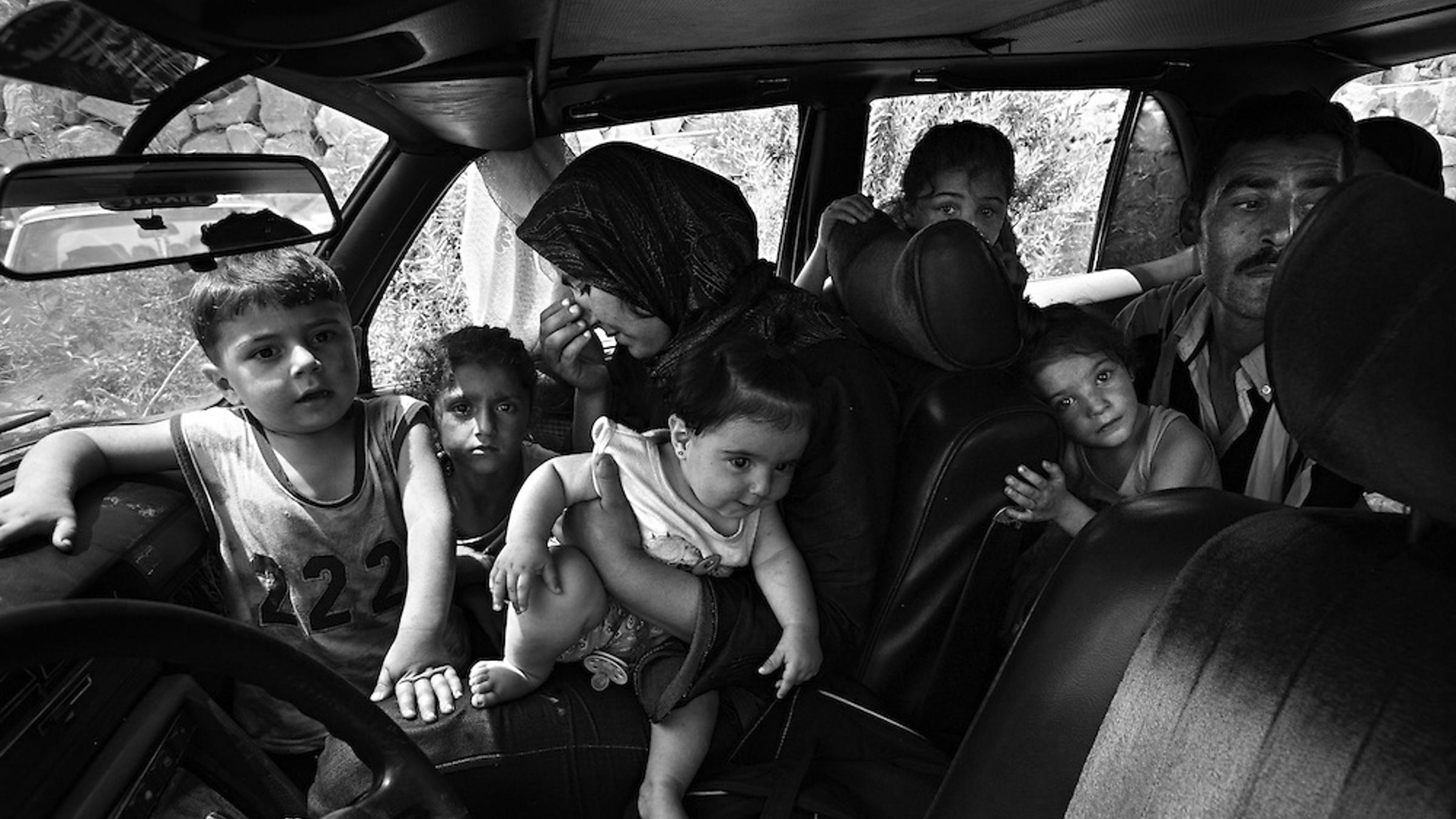 Families from the border towns of Lebanon flee through the very dangerous coastal road between Tyre and Sidon.