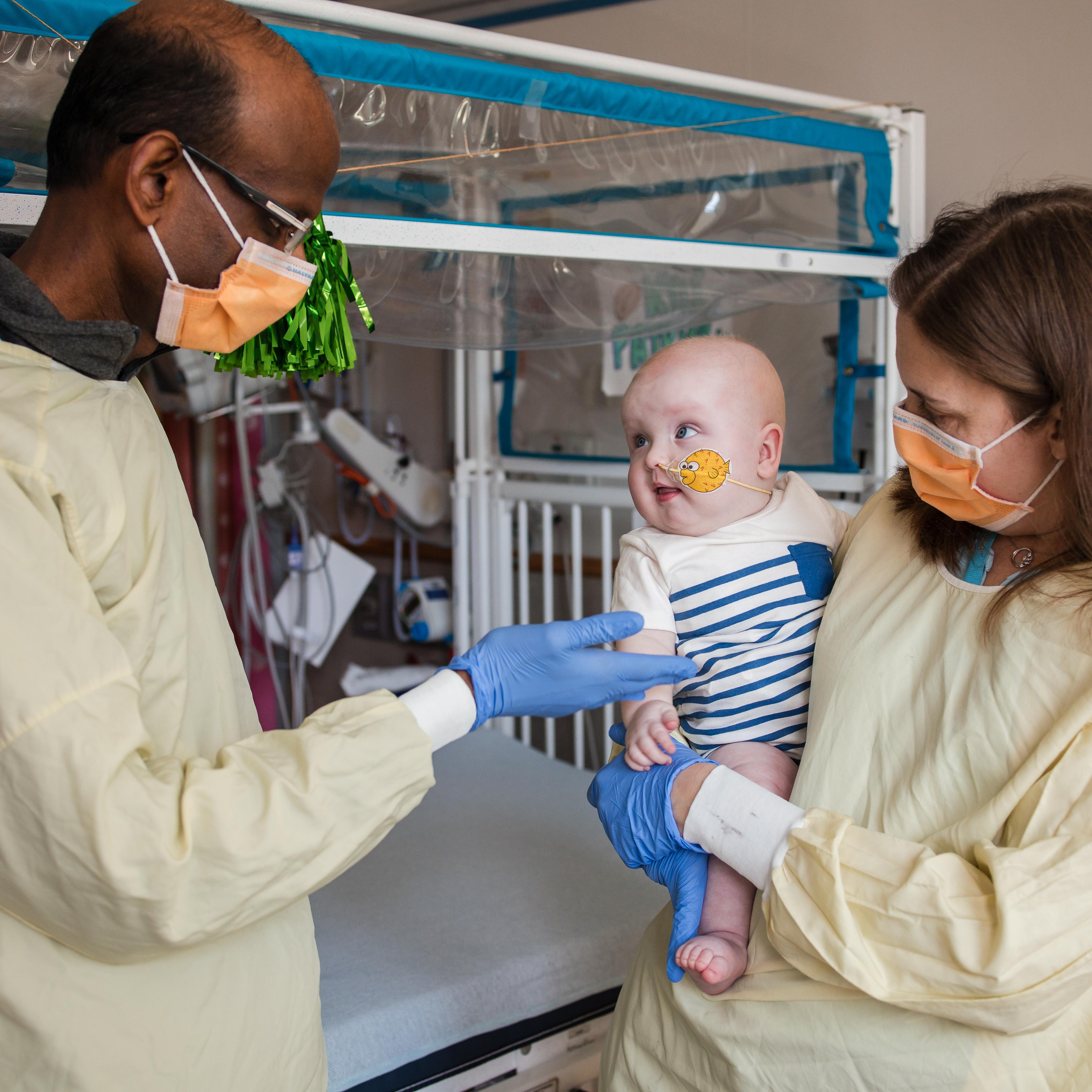 Dr. Musunuru and Dr. Ahrens-Nicklas holding KJ post infusion