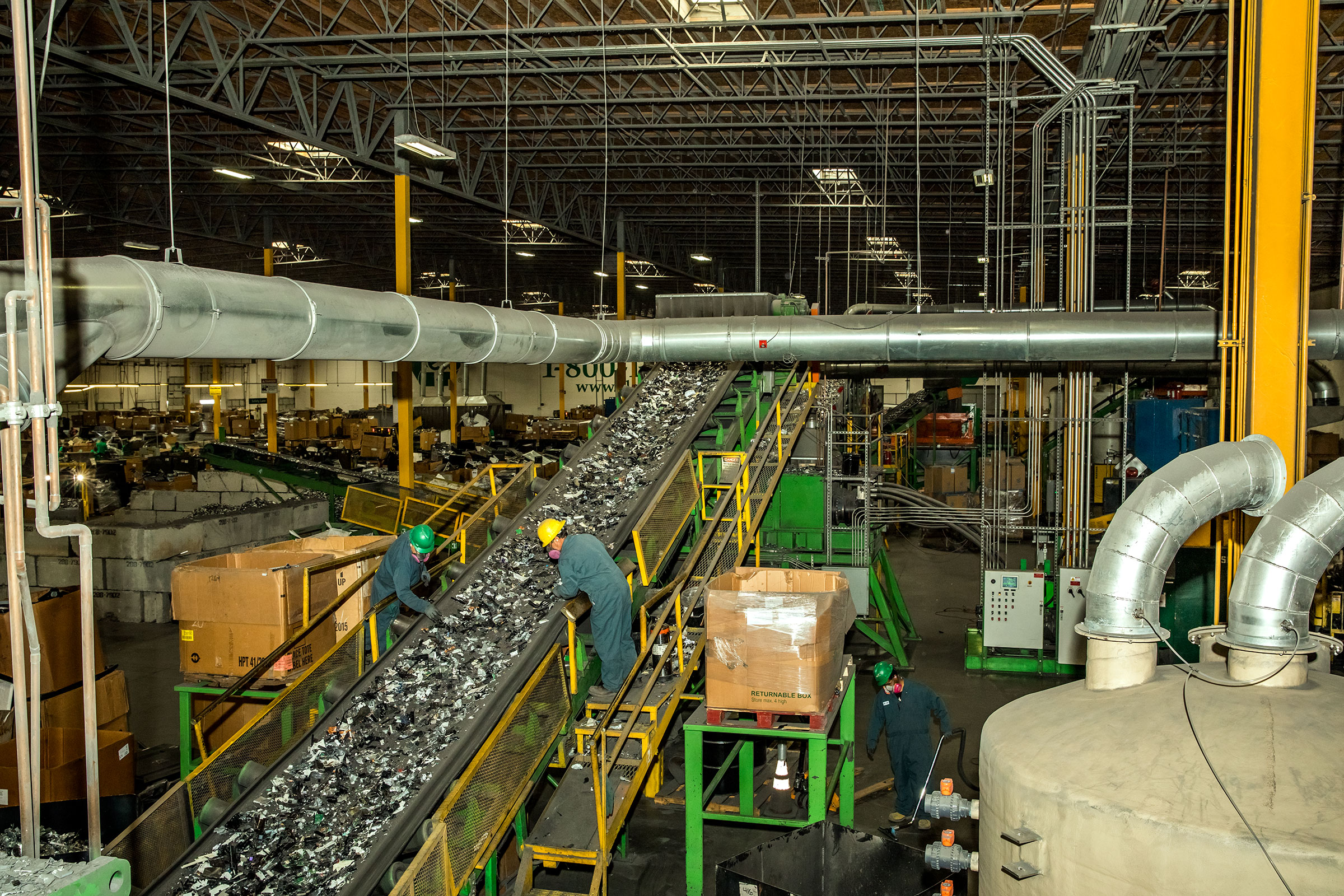 Workers sort through discarded electronics at ERI’s Fresno facility