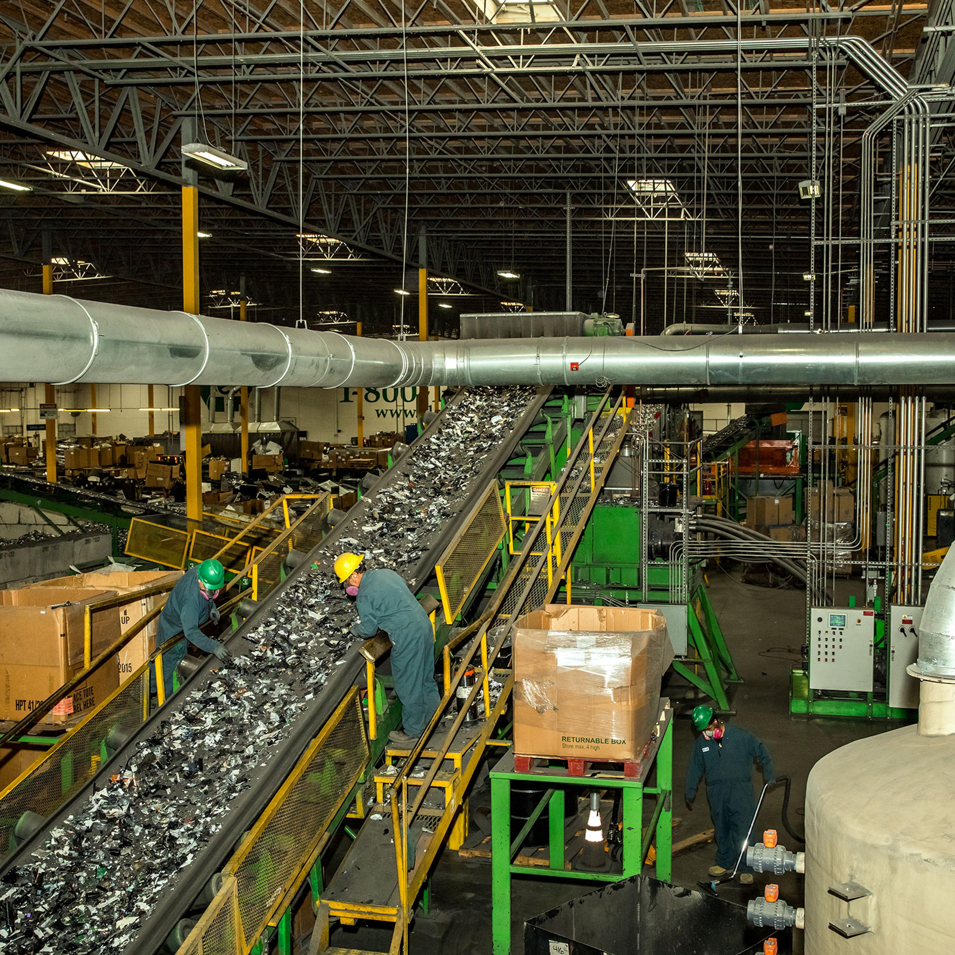 Workers sort through discarded electronics at ERI’s Fresno facility