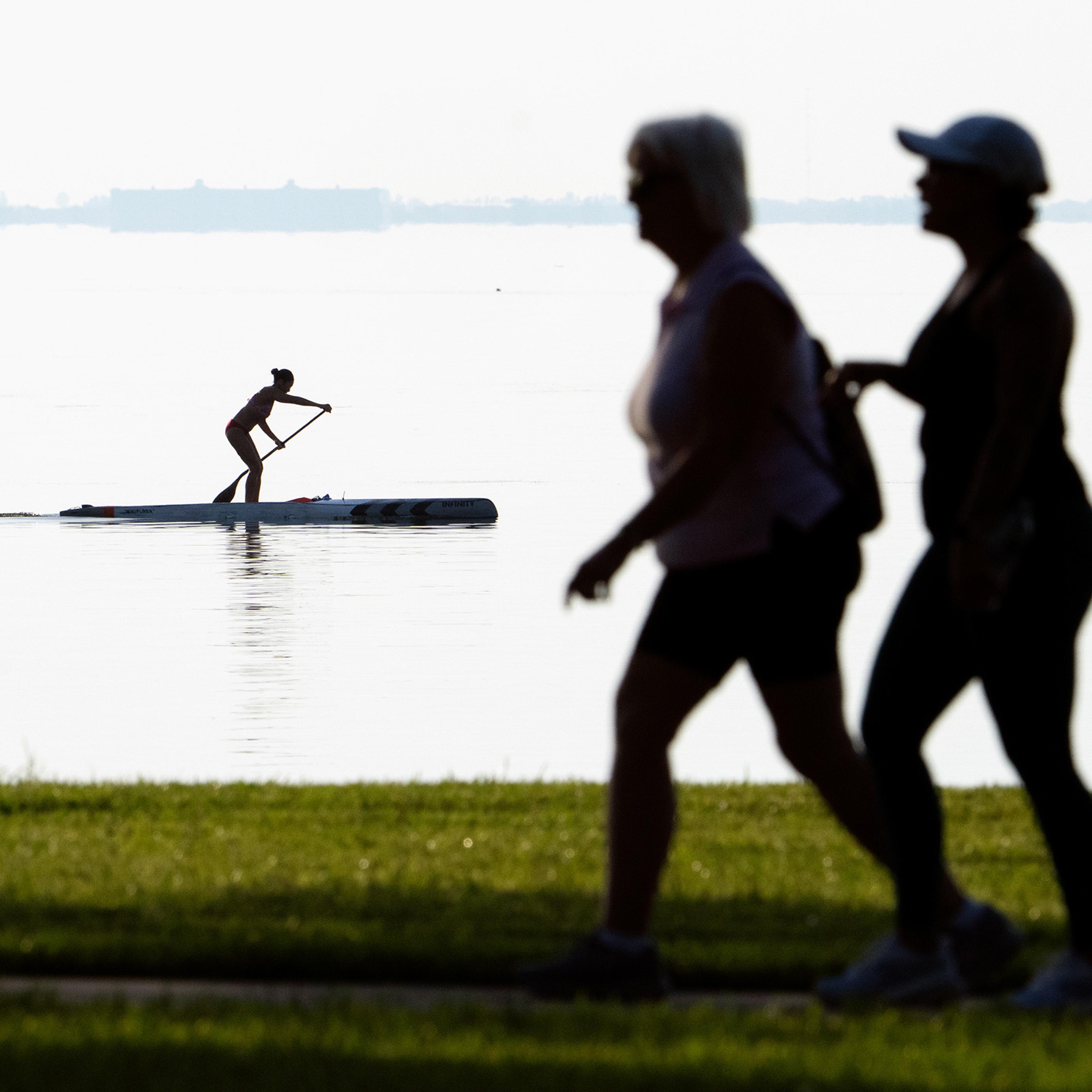 Women walking near water.