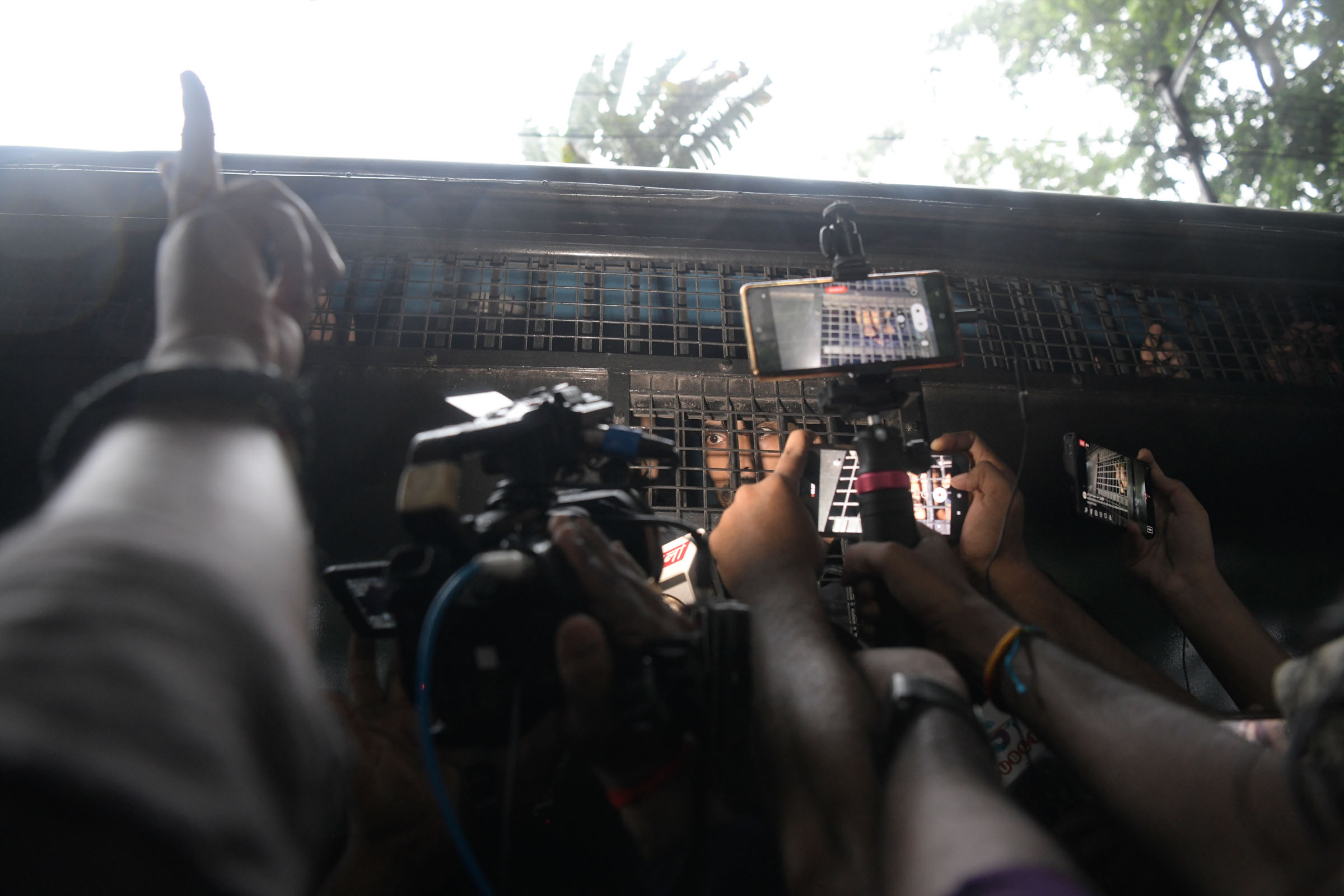 A detained protester is seen being interviewed by the media