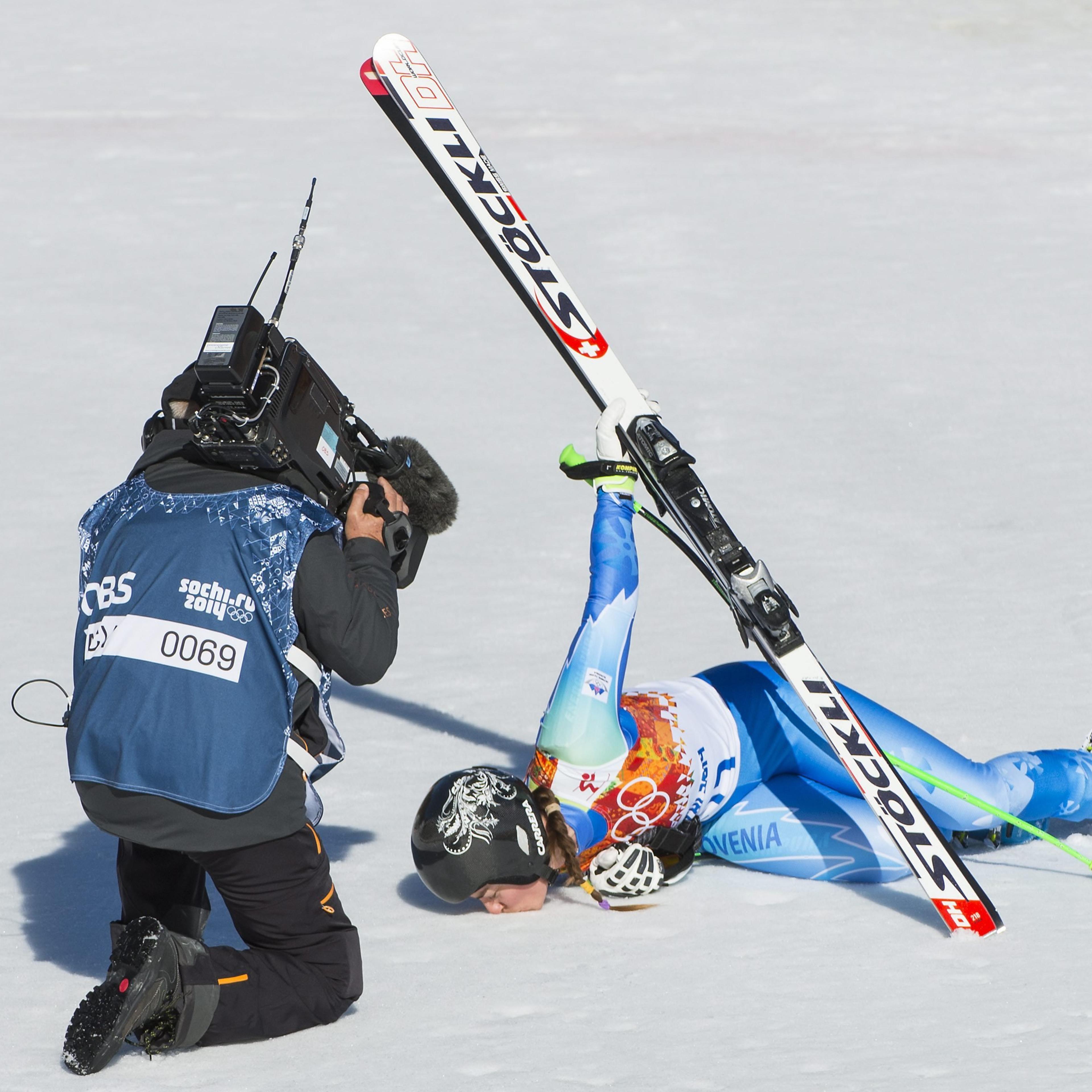 Tina Maze of Slovenia kisses the snow in the finish area during the Women's Alpine Skiing Downhill race in Rosa Khutor Alpine Center.