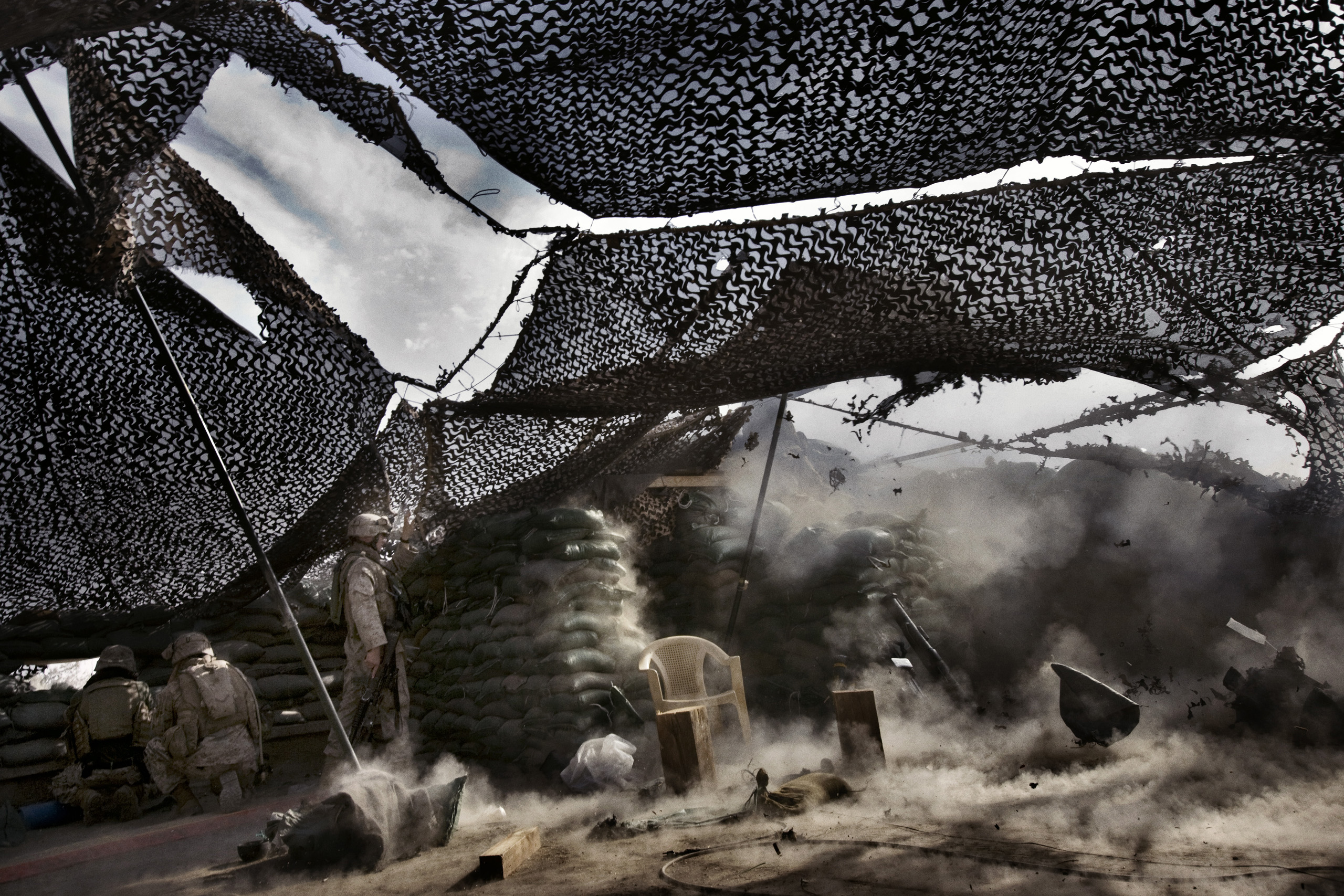 U.S. Marines from the 3rd Battalion, 8th Marine Regiment, Kilo company open fire on insurgents from the observation's post on the roof of the main Iraqi government building complex, Ramadi, Iraq, April 29, 2006. The Marines are guarding the government co