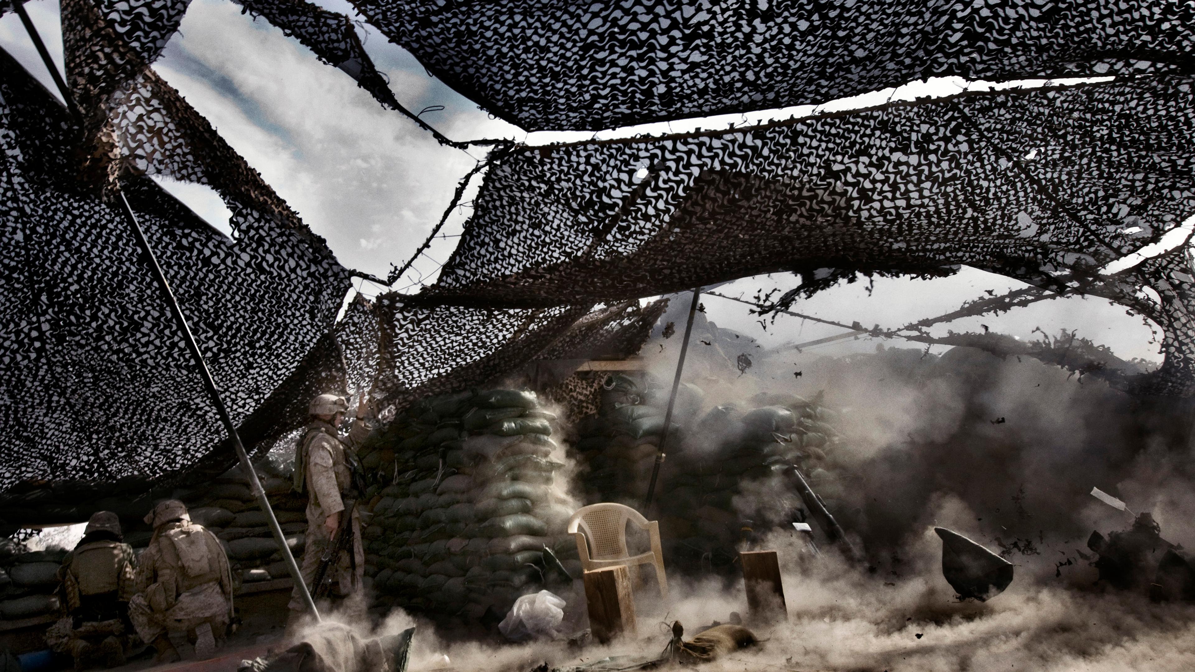 U.S. Marines from the 3rd Battalion, 8th Marine Regiment, Kilo company open fire on insurgents from the observation's post on the roof of the main Iraqi government building complex, Ramadi, Iraq, April 29, 2006. The Marines are guarding the government co