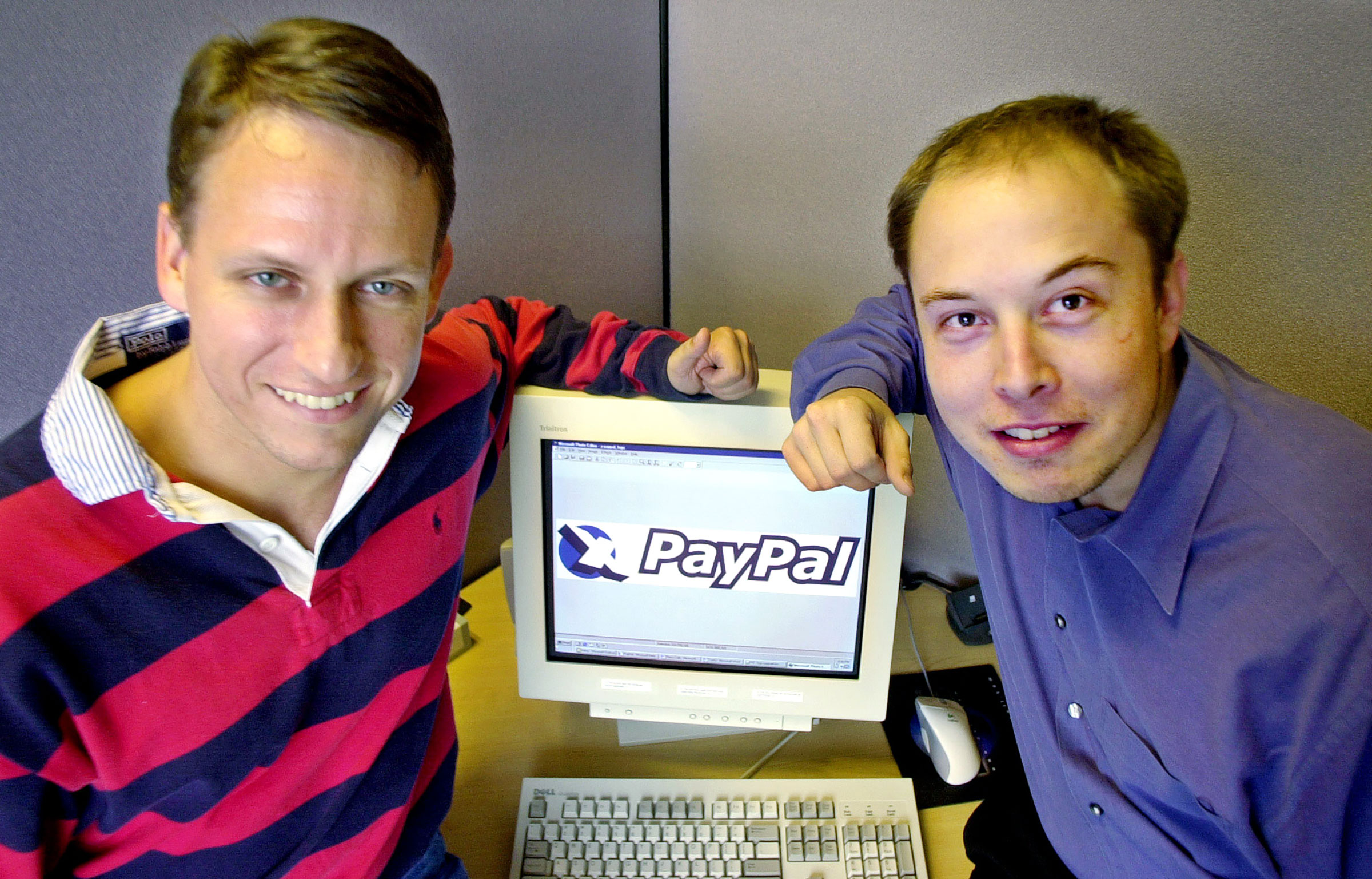 PayPal Chief Executive Officer Peter Thiel, left, and founder Elon Musk, right, pose with the PayPal logo at corporate headquarters in Palo Alto, Calif. on Oct. 20, 2000.