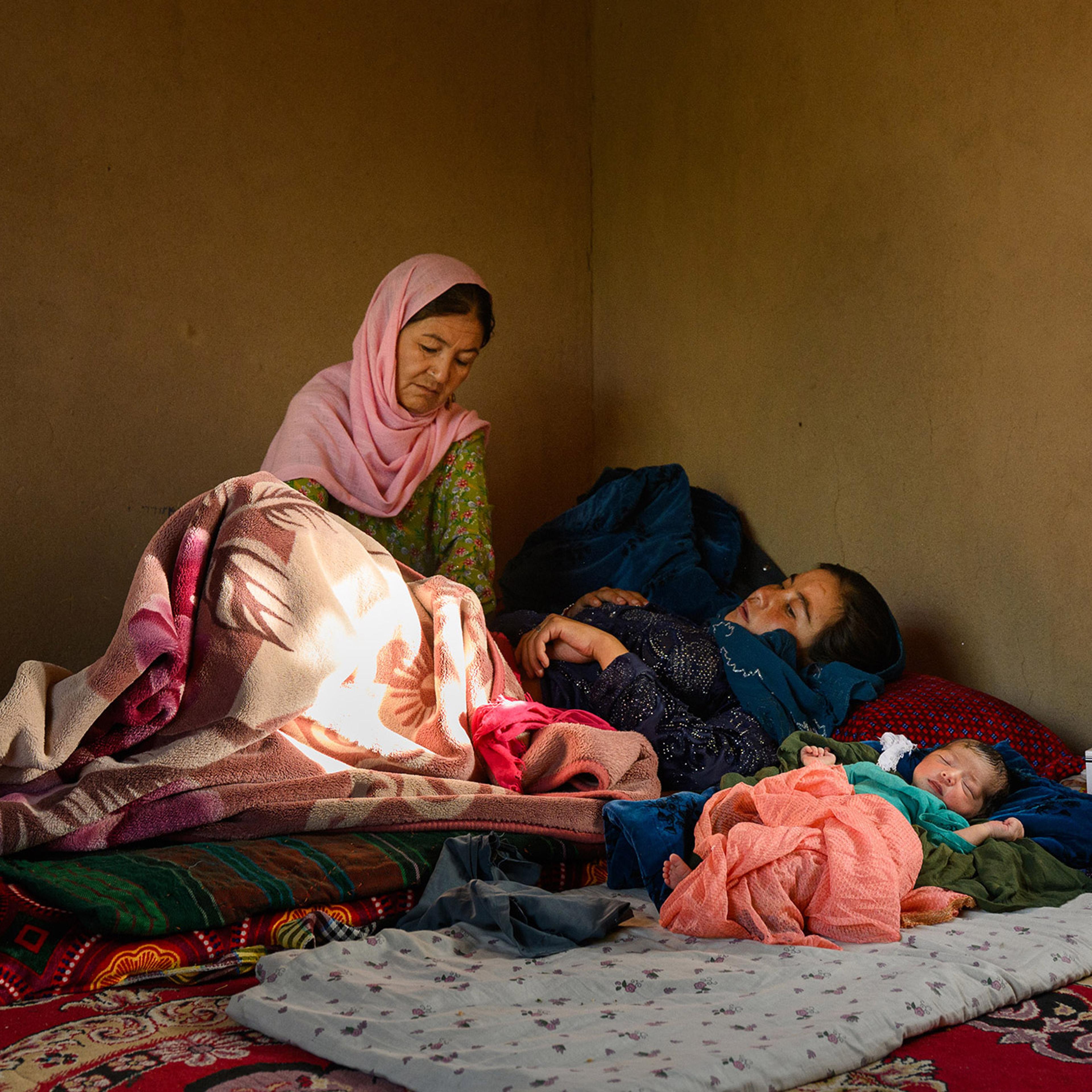 Gul Chaman, a 43-year-old midwife in Afghanistan’s central Daikundi province, visits a patient and her newborn daughter in July.