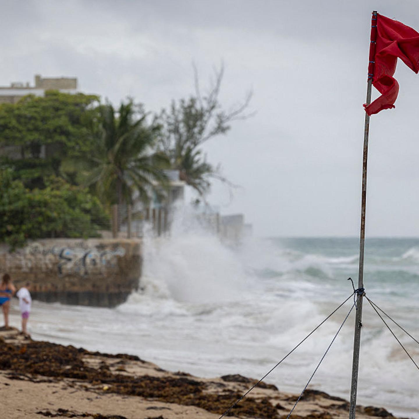 A ripped red flag warning of rip current waves as Category 5 Hurricane Erin approaches in San Juan, Puerto Rico, on August 16, 2025. Hurricane Erin on Saturday strengthened to a "catastrophic" Category 5 storm as it barrelled towards the Caribbean, with weather officials warning of possible flash floods and landslides.