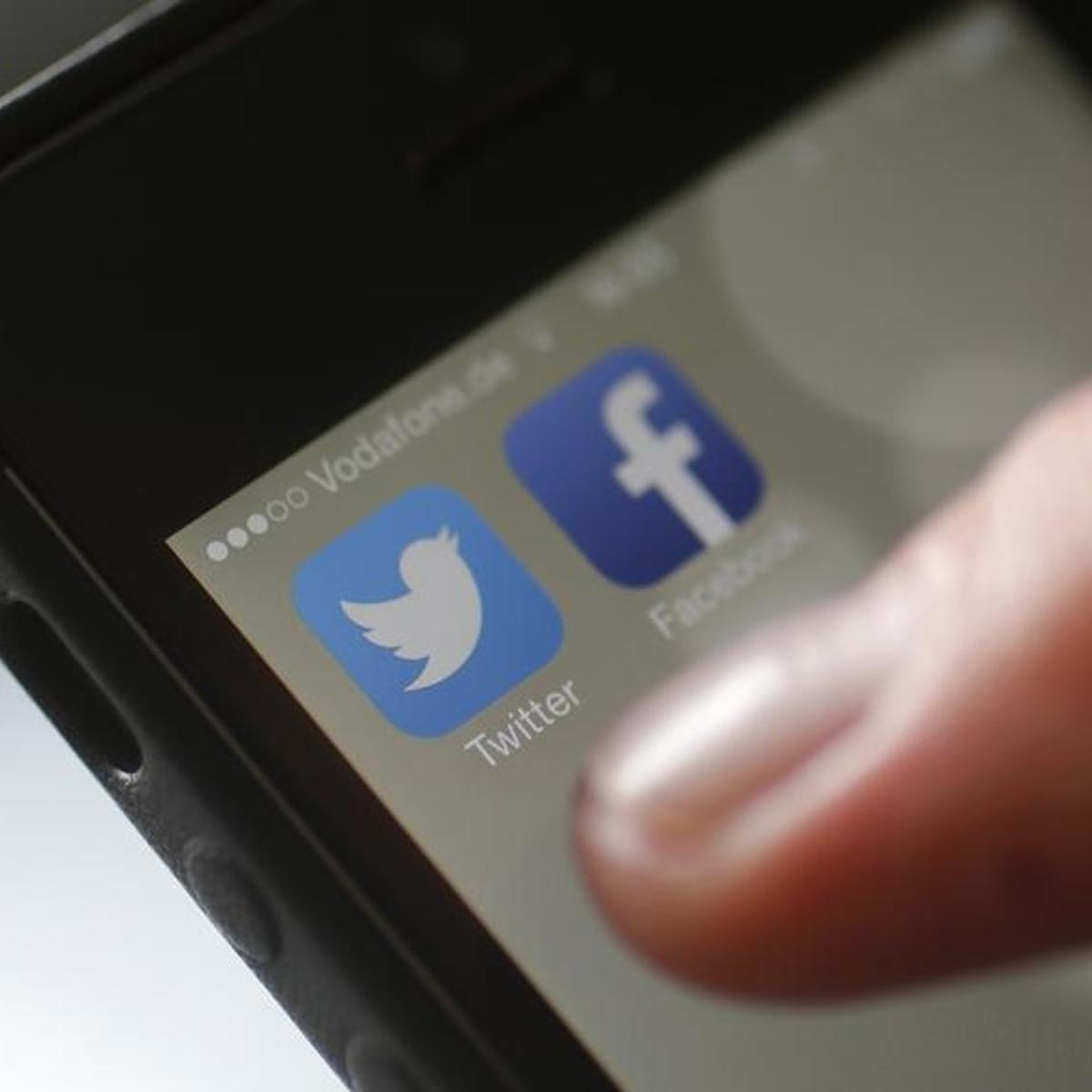 An illustration picture shows a man starting his Twitter App on a mobile device in Hanau near Frankfurt