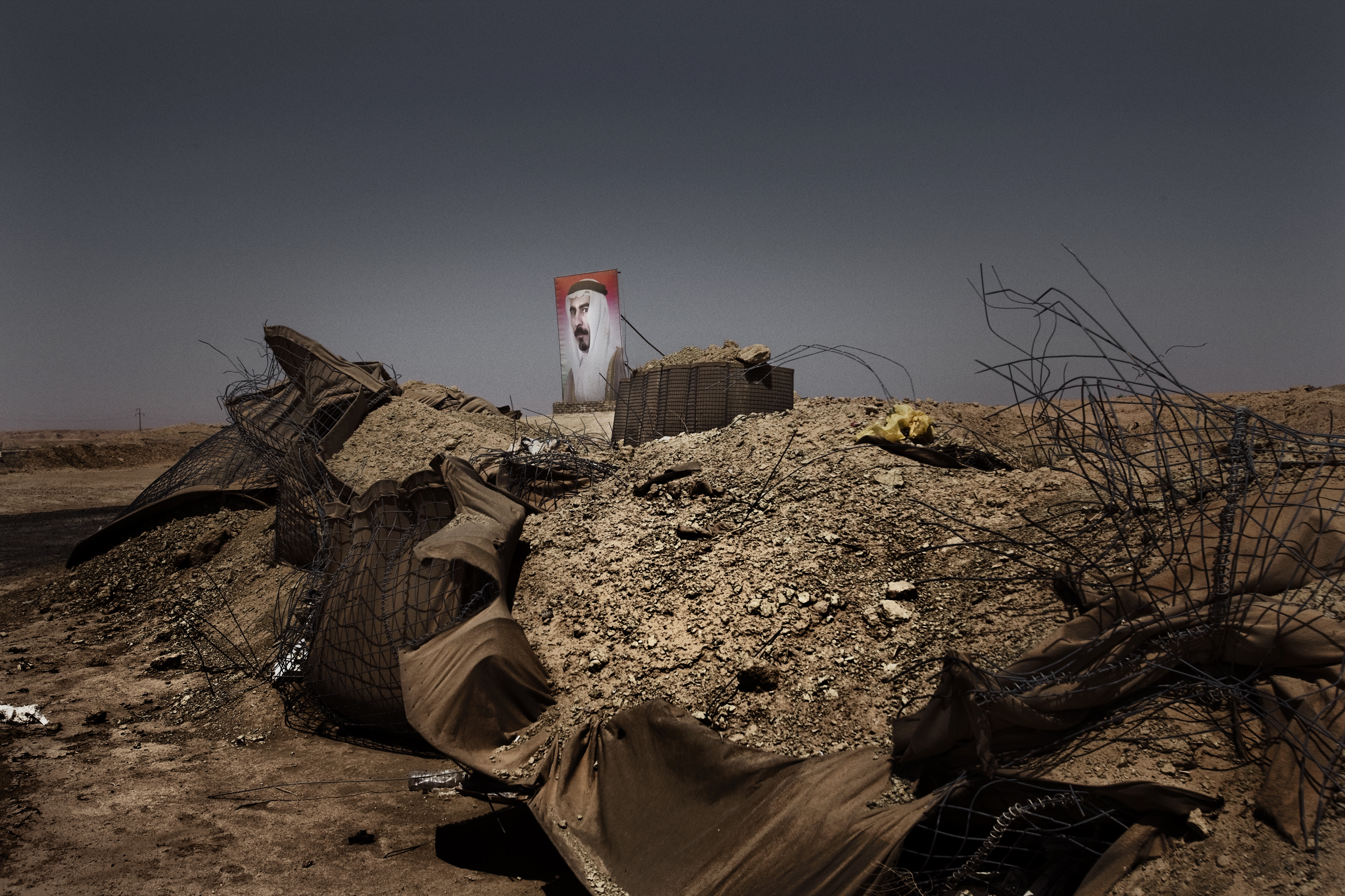 A billboard showing the face of Sheikh Sattar Abu Risha founder and hero of the Awakening movement who was assassinated by a suicide bomb in 2007 outside of Zangura in Iraq's desert in Anbar province--where some of the fiercest battles between U.S. force