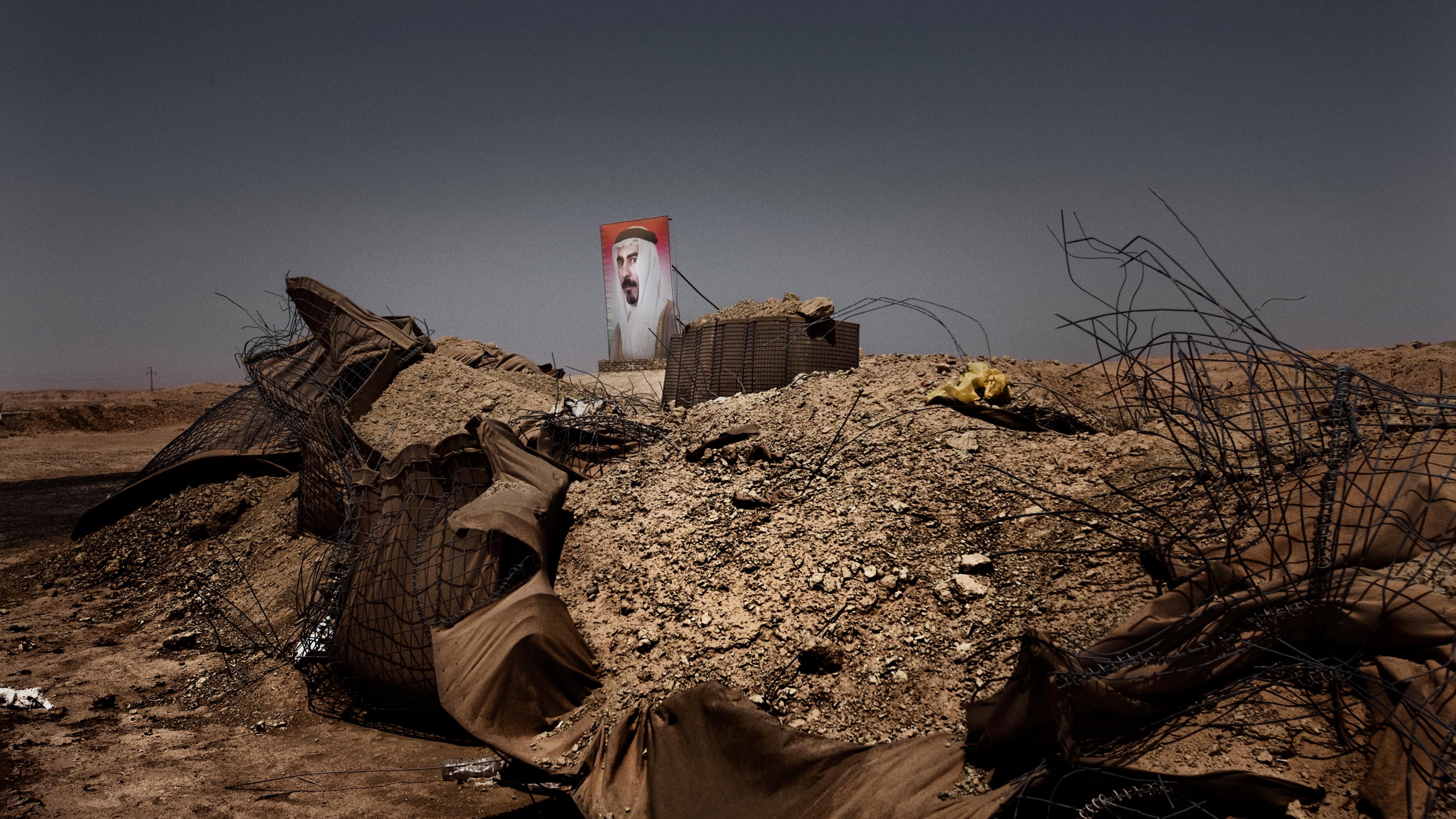 A billboard showing the face of Sheikh Sattar Abu Risha founder and hero of the Awakening movement who was assassinated by a suicide bomb in 2007 outside of Zangura in Iraq's desert in Anbar province--where some of the fiercest battles between U.S. force