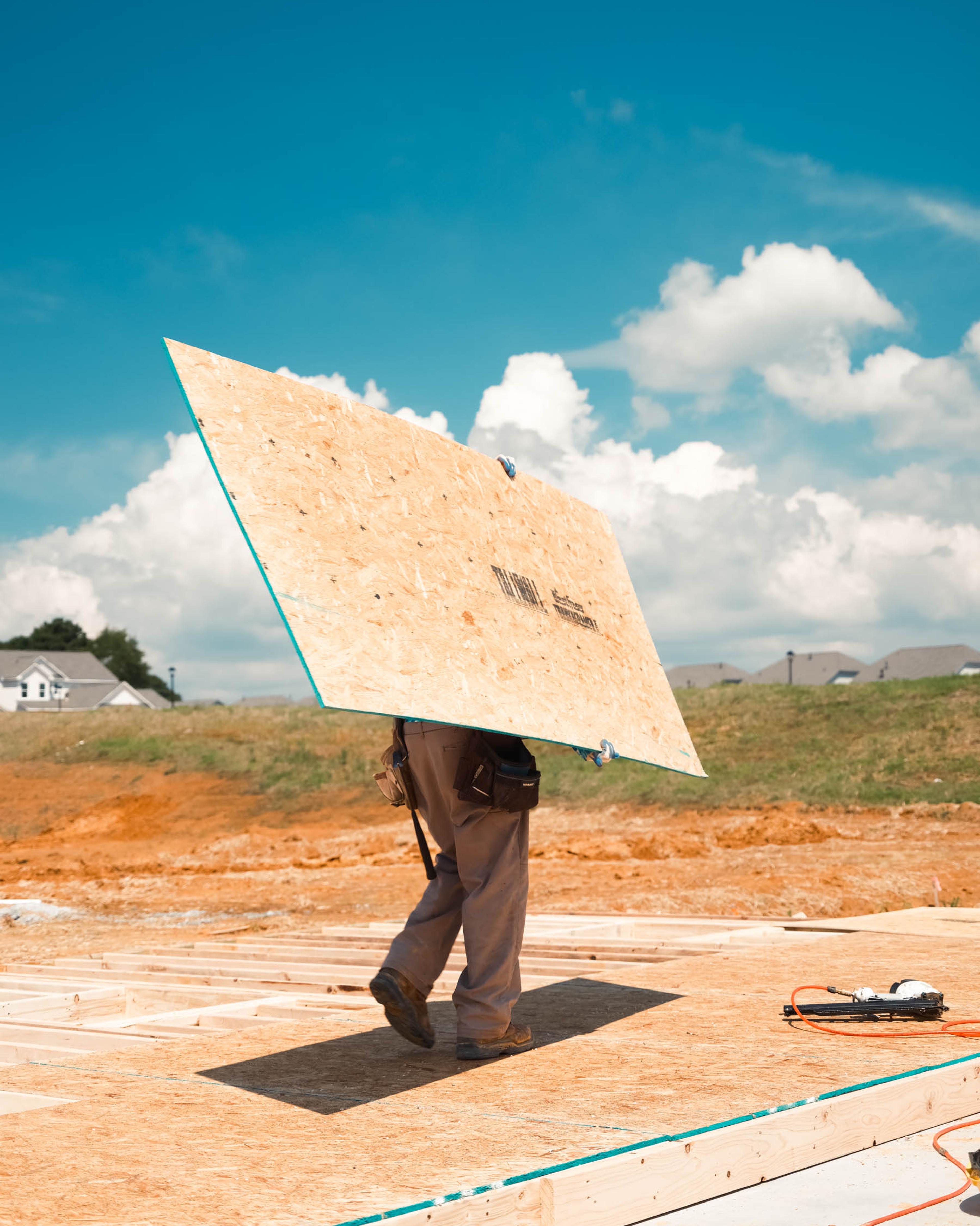 Construction workers toil in the heat working on a new subdivision being built in Loganville, Ga., in July 2023.
