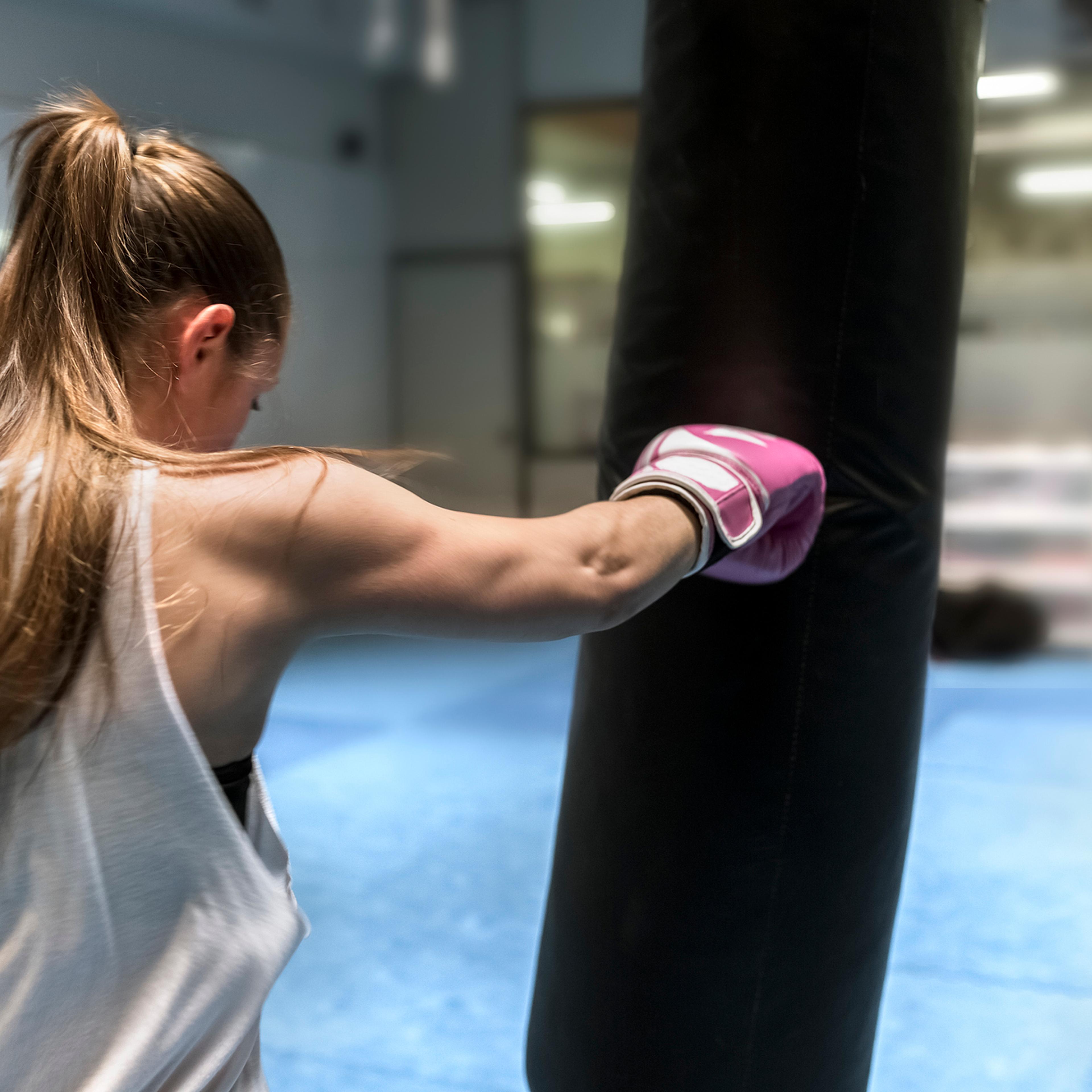 Young woman boxing in gym