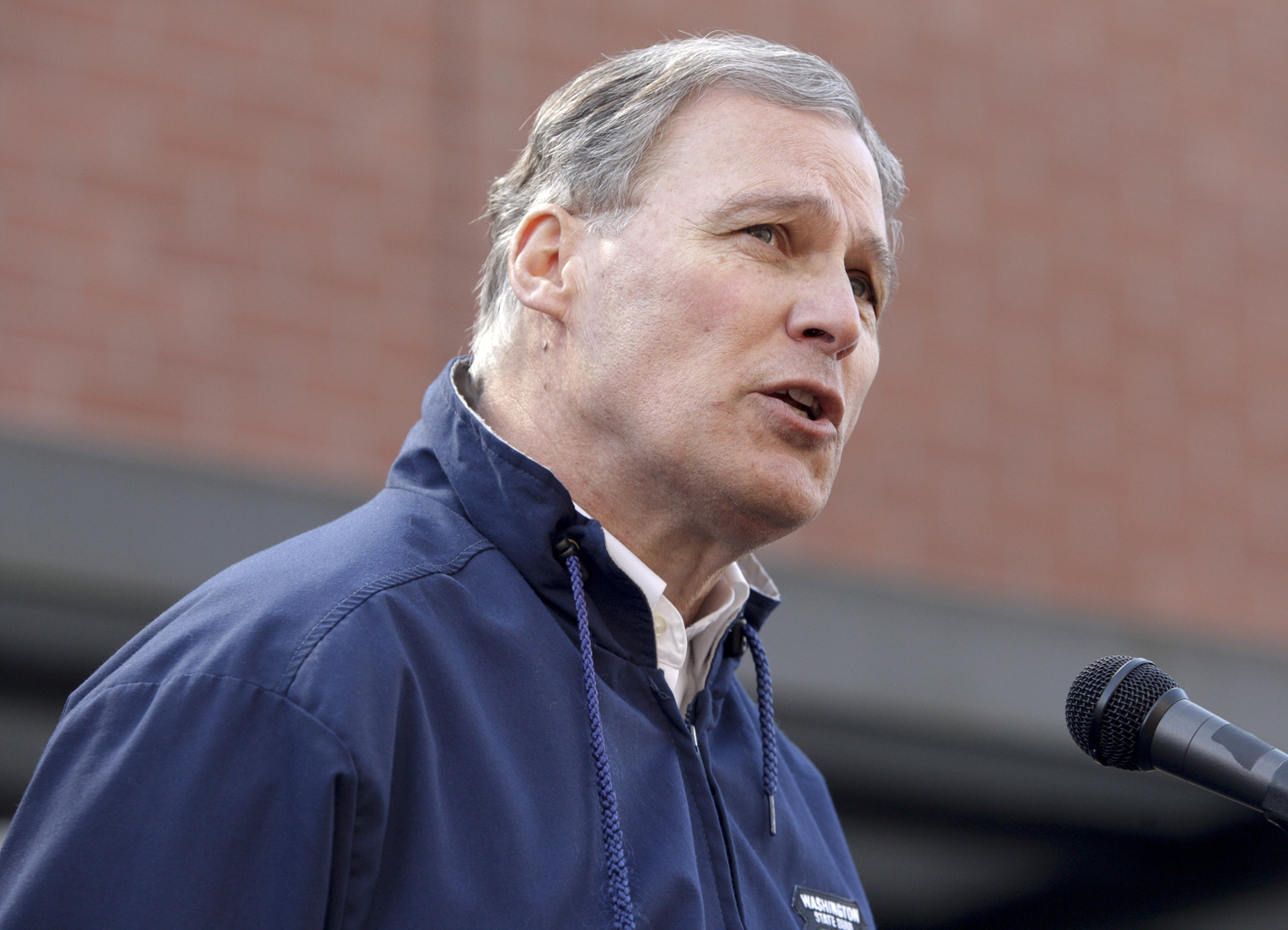 Governor Jay Inslee addresses the media outside the Arlington Police Department in Arlington, Washington