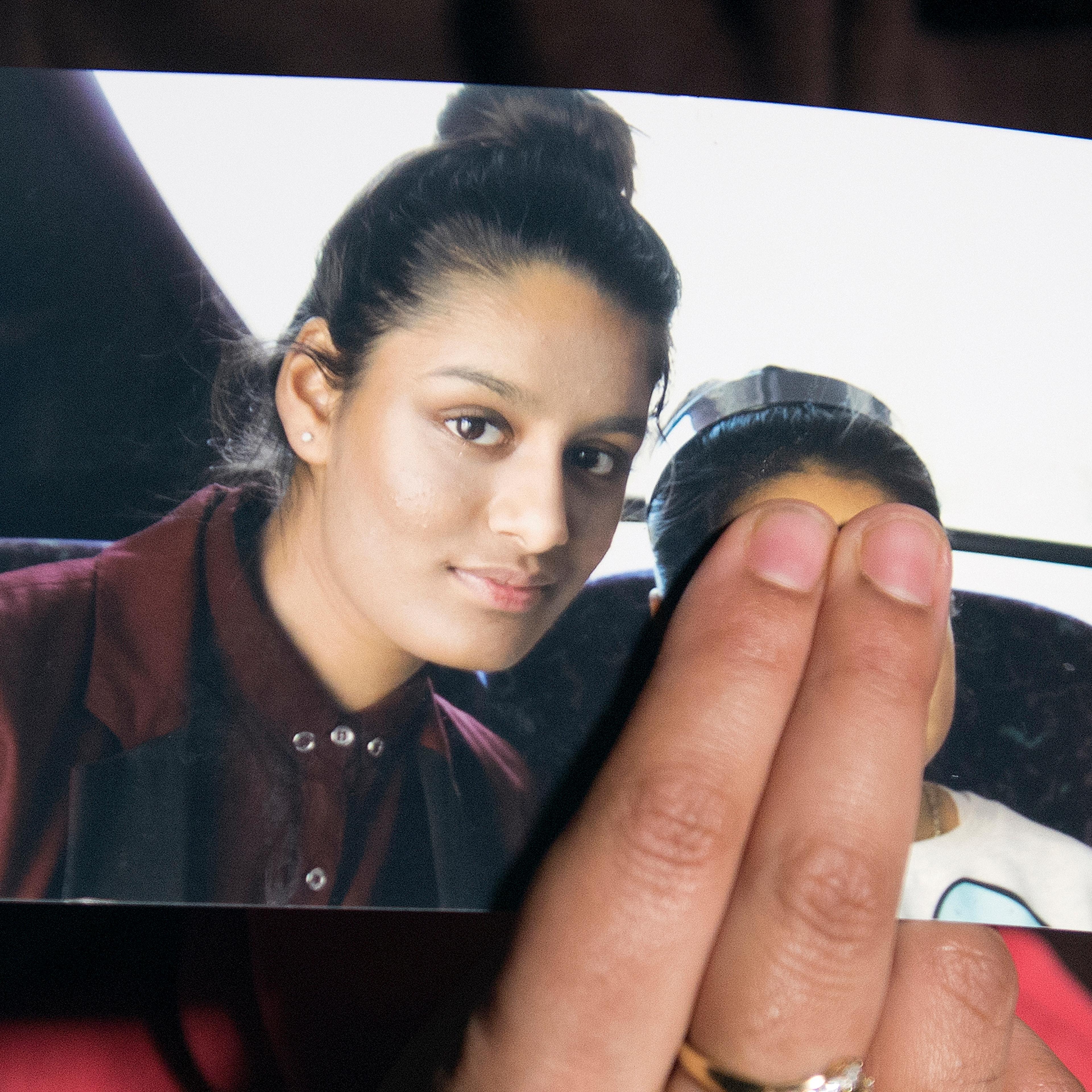 Renu Begun, sister of teenage British girl Shamima Begun, holds a photo of her sister as she makes an appeal for her to return home at Scotland Yard, in London