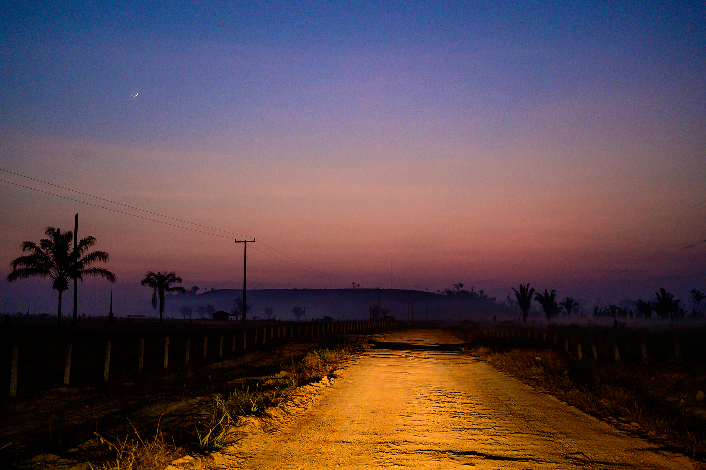 A dirt road is illuminated in the region of Vila Nova Samuel, near the Jacundá National Forest, on Aug. 28.