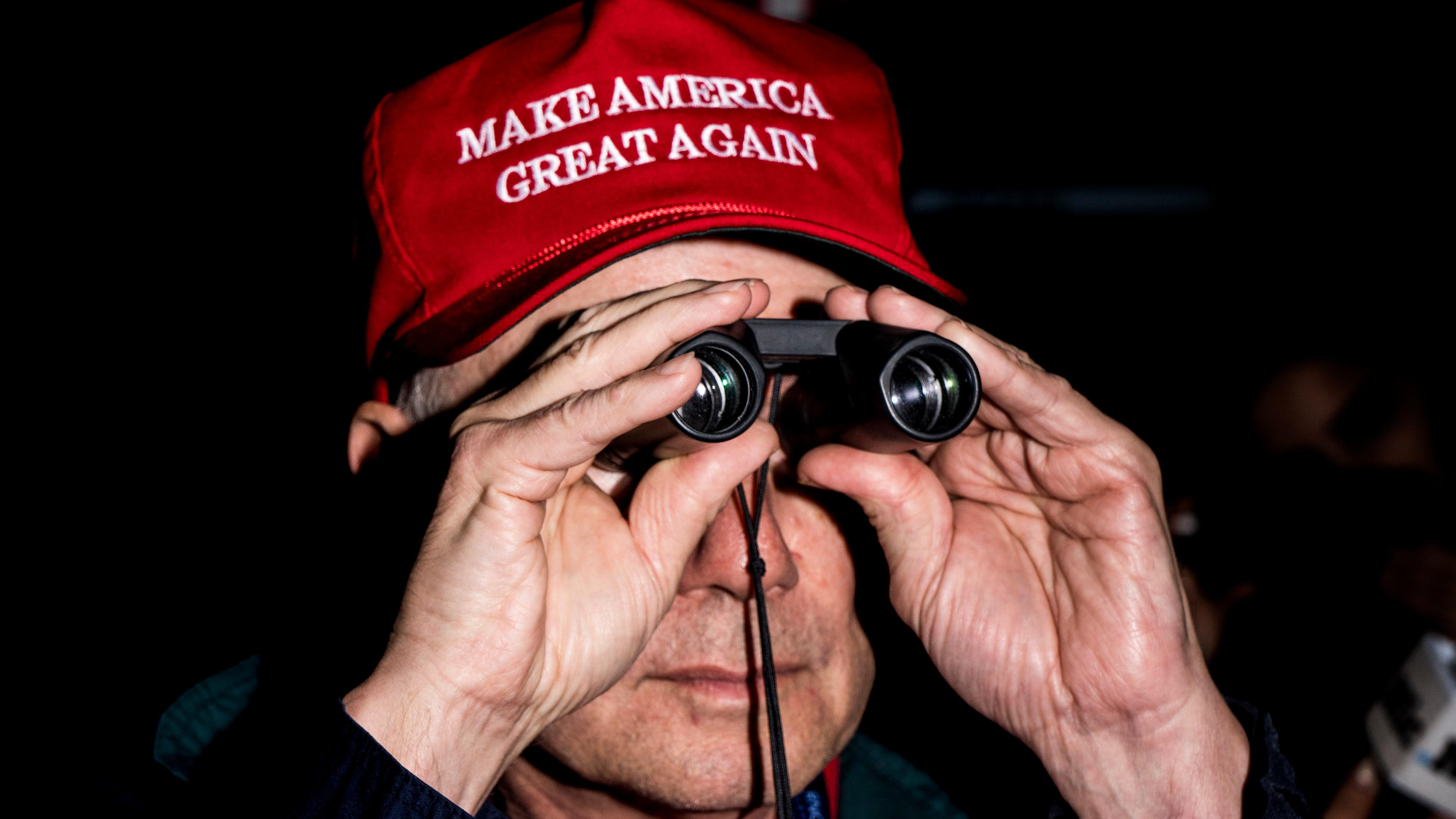 A man dons a "Make America Great Again" hat at the Republican National Convention in Cleveland.