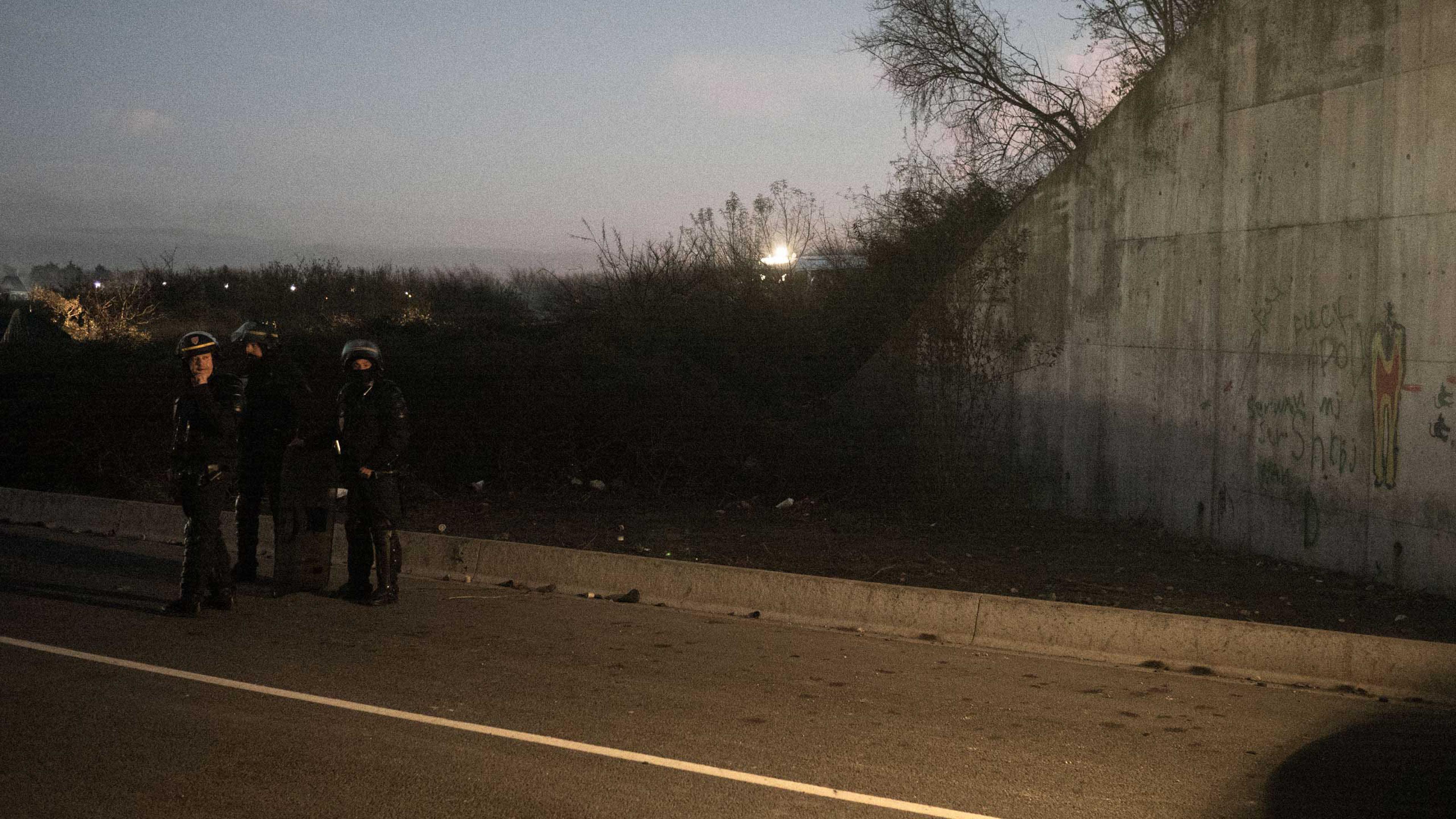 Anti-riot police (CRS) during a tense face-off with a group of migrants. As it has become harder for migrants to cross to the United Kingdom, confrontations with police have become more frequent, Nov. 25, 2015, Calais, France.