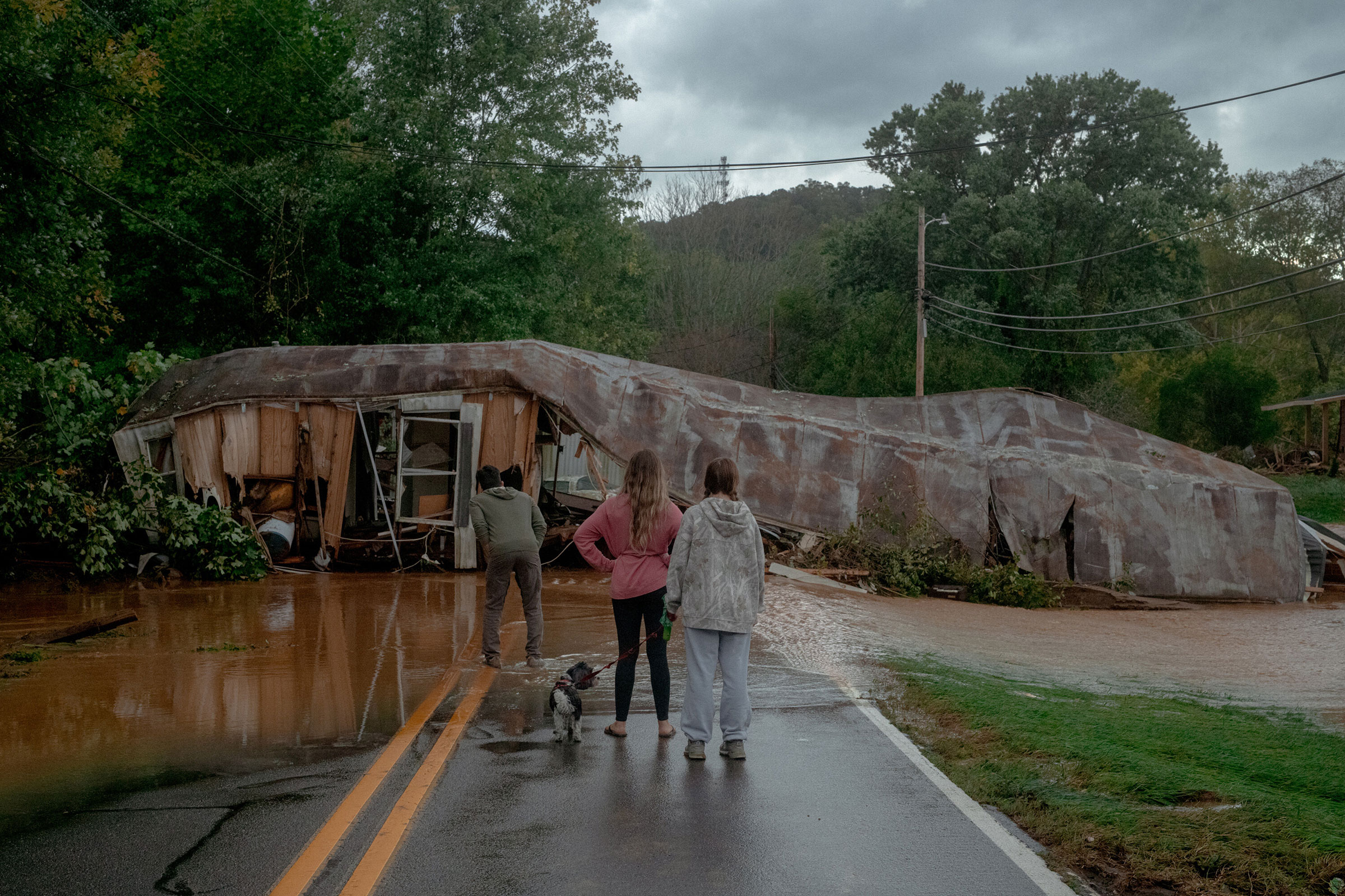 Floodwaters and a destroyed building block a road in Swannanoa, N.C., Sept. 27, 2024. (Mike Belleme/The New York Times)