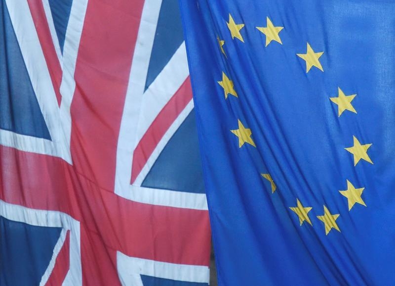 A Union flag flies next to the flag of the European Union in Westminster, London