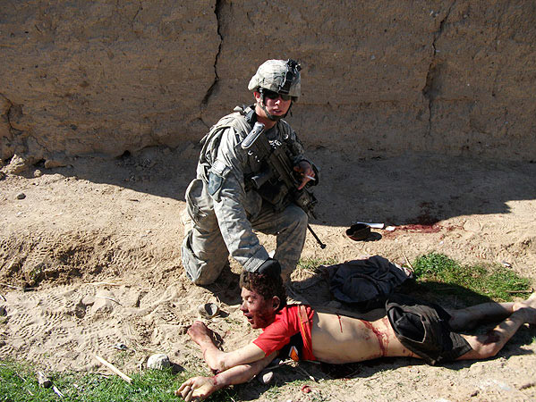 This image, published by <a href="http://www.rollingstone.com/politics/photos/the-kill-team-photos-20110327/0859078">Rolling Stone</a>, shows the body of Gul Mudin, the son of a farmer, who was killed on Jan. 15, 2010. Pfc. Andrew Holmes, a member of the "kill team" is posing next to him.