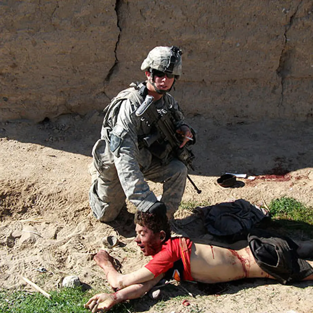 This image, published by <a href="http://www.rollingstone.com/politics/photos/the-kill-team-photos-20110327/0859078">Rolling Stone</a>, shows the body of Gul Mudin, the son of a farmer, who was killed on Jan. 15, 2010. Pfc. Andrew Holmes, a member of the "kill team" is posing next to him.