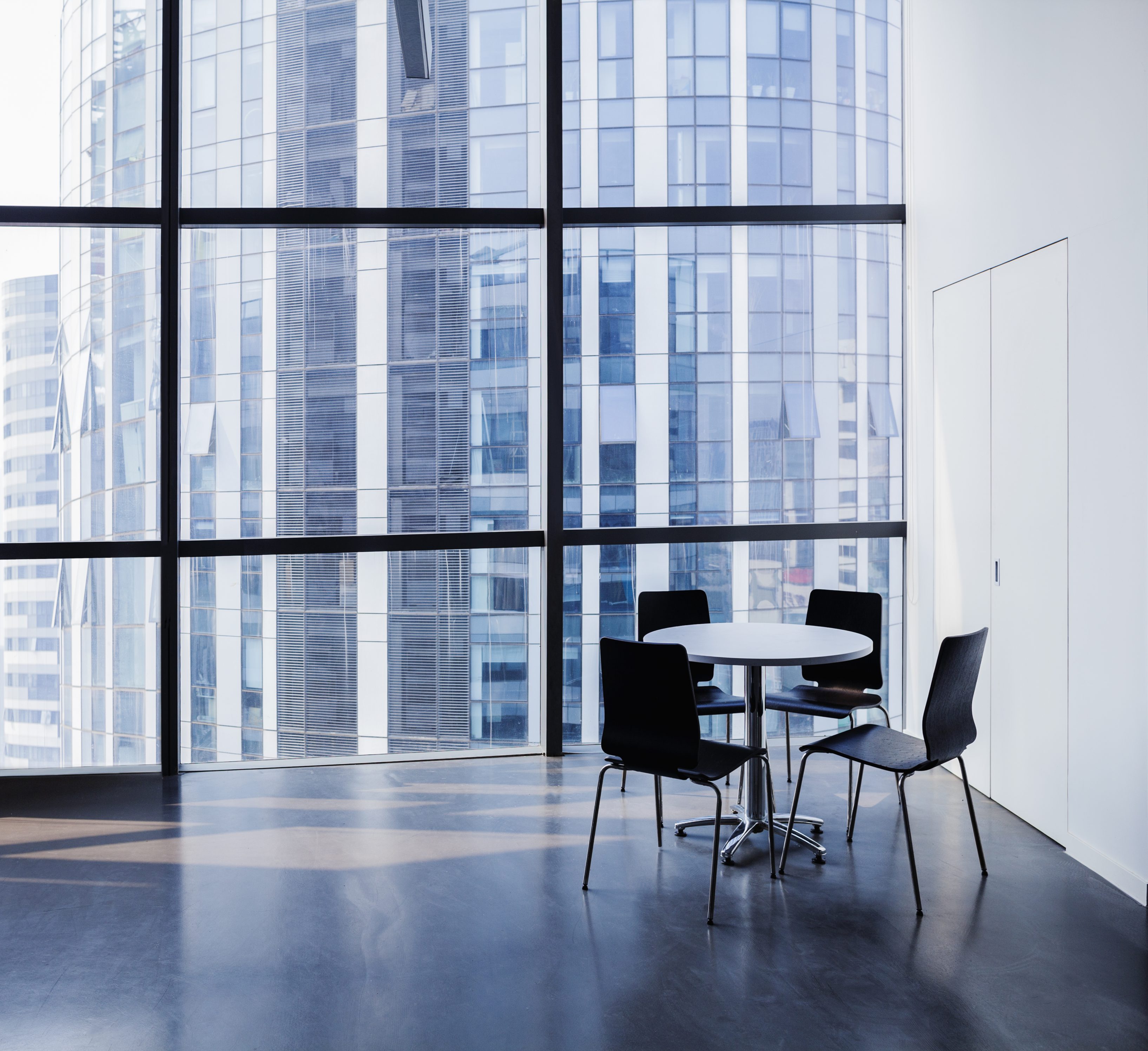 Empty modern office with table and four chairs