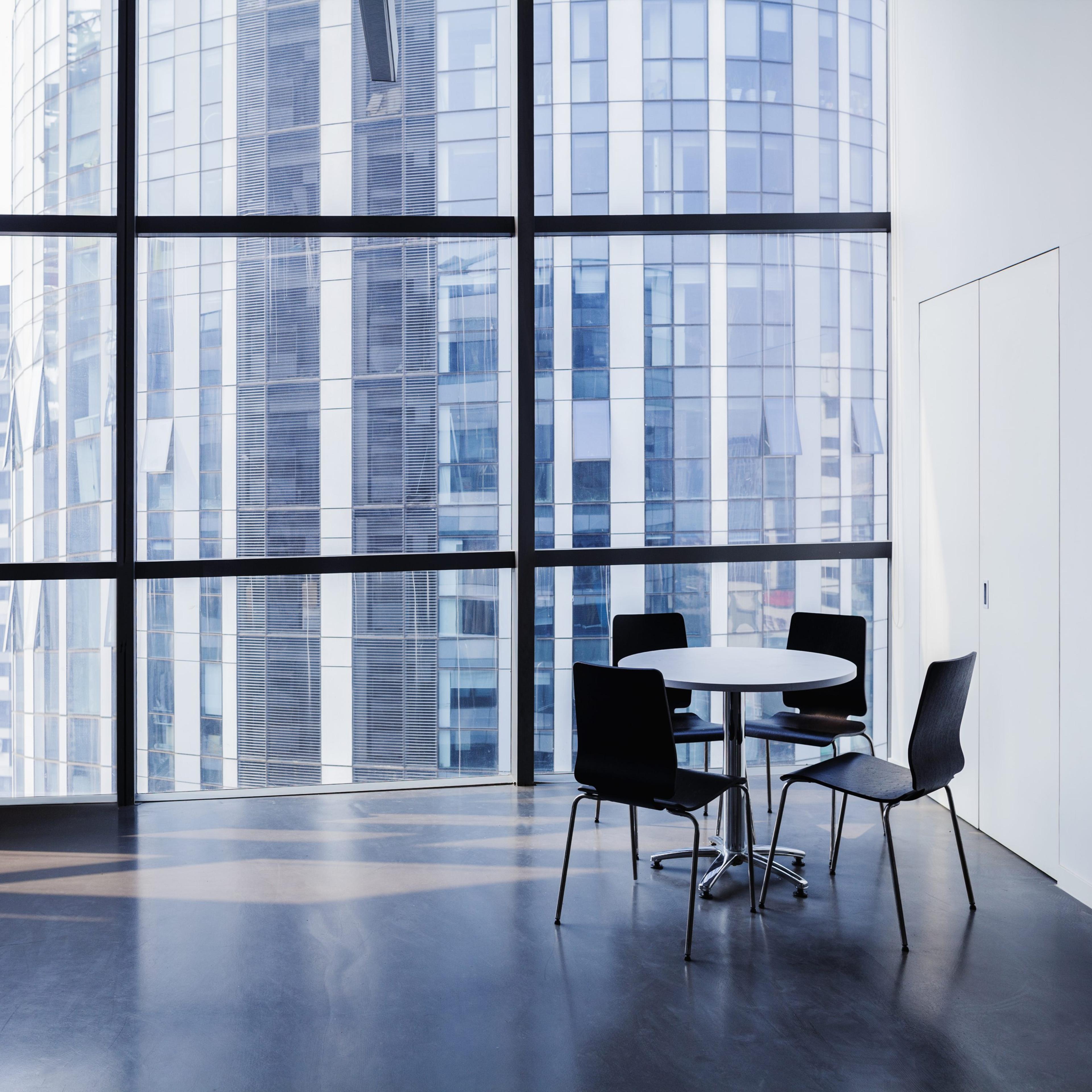 Empty modern office with table and four chairs