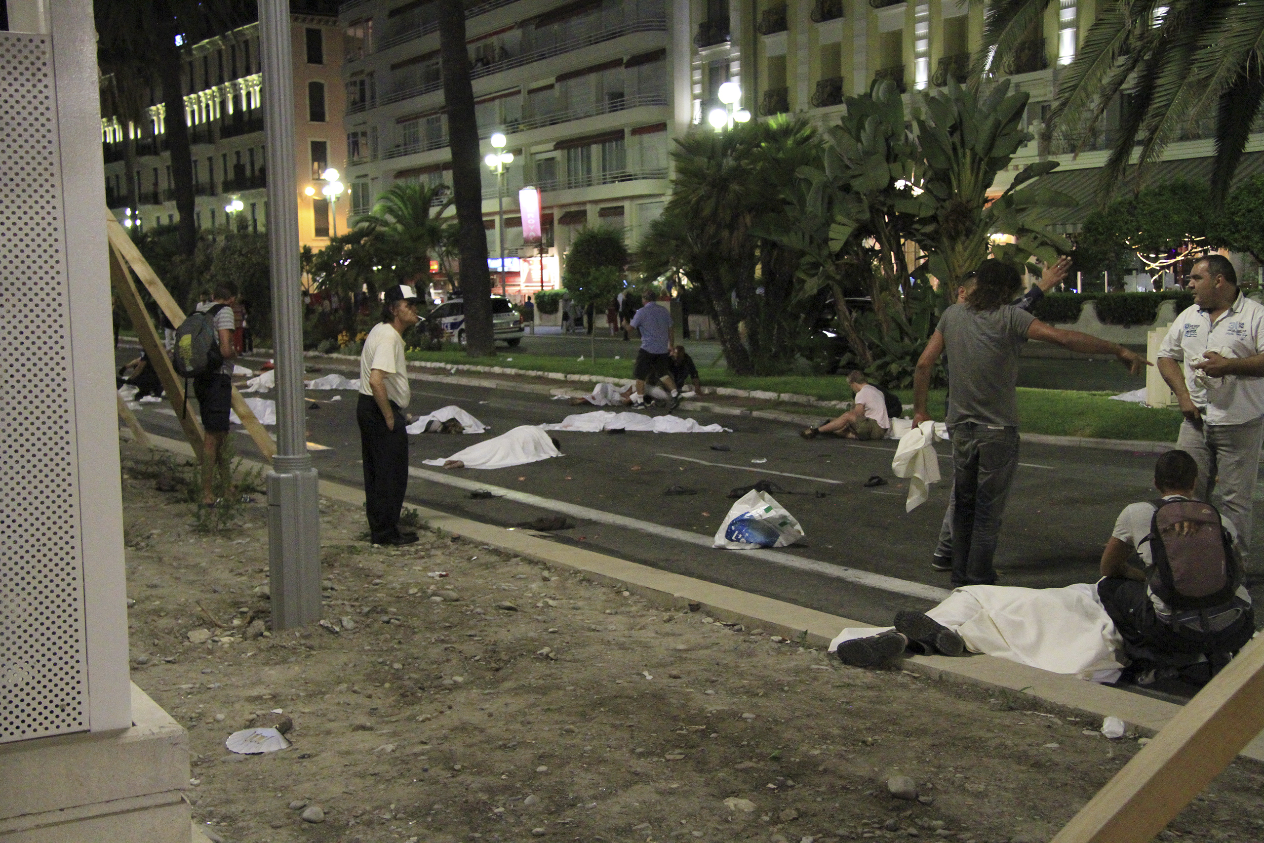 Covered bodies lie on the street after a truck crashed into a crowd along the Promenade des Anglais in Nice, France, during celebrations of Bastille Day on July 14, 2016.