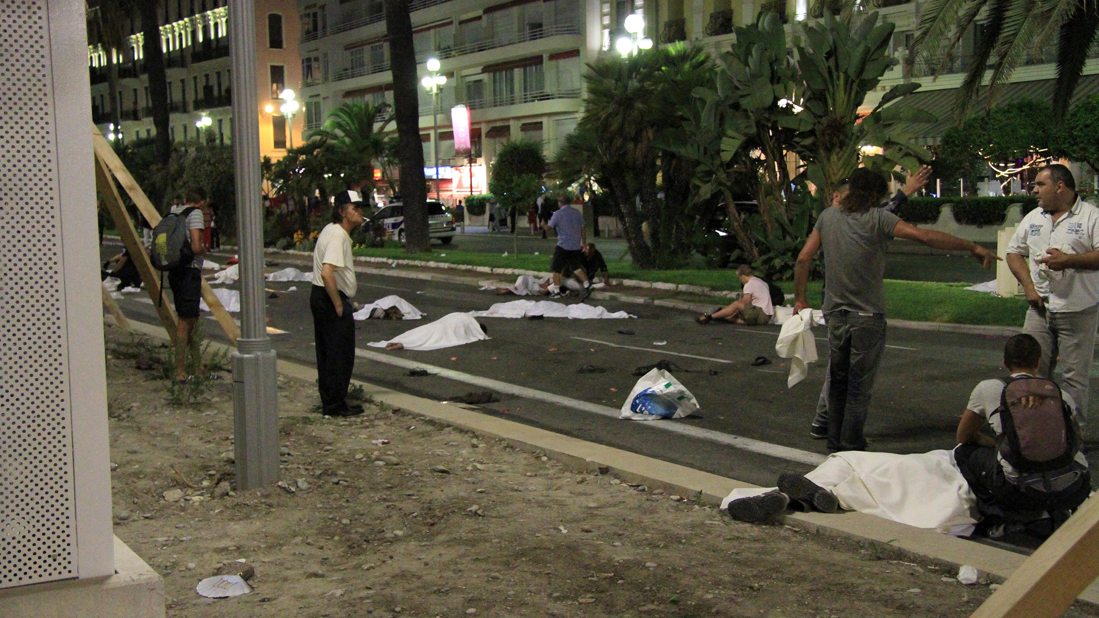 Covered bodies lie on the street after a truck crashed into a crowd along the Promenade des Anglais in Nice, France, during celebrations of Bastille Day on July 14, 2016.