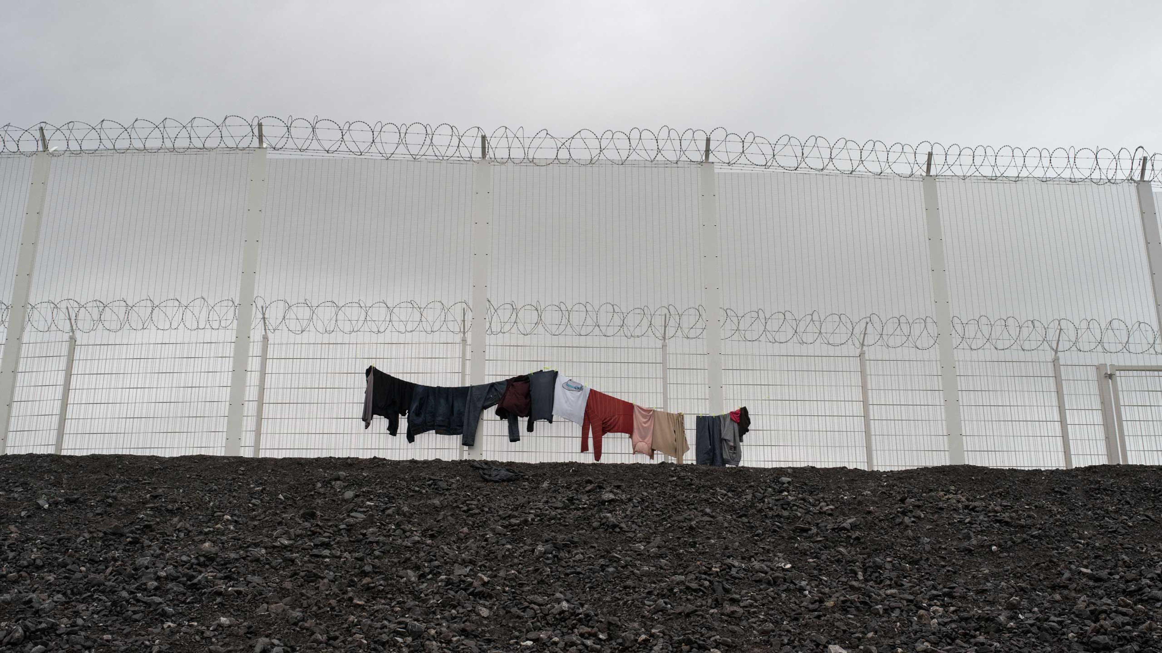 Clothes hang to dry on the fence of the Calais, France shantytown, known as the "jungle," Nov. 24, 2015.