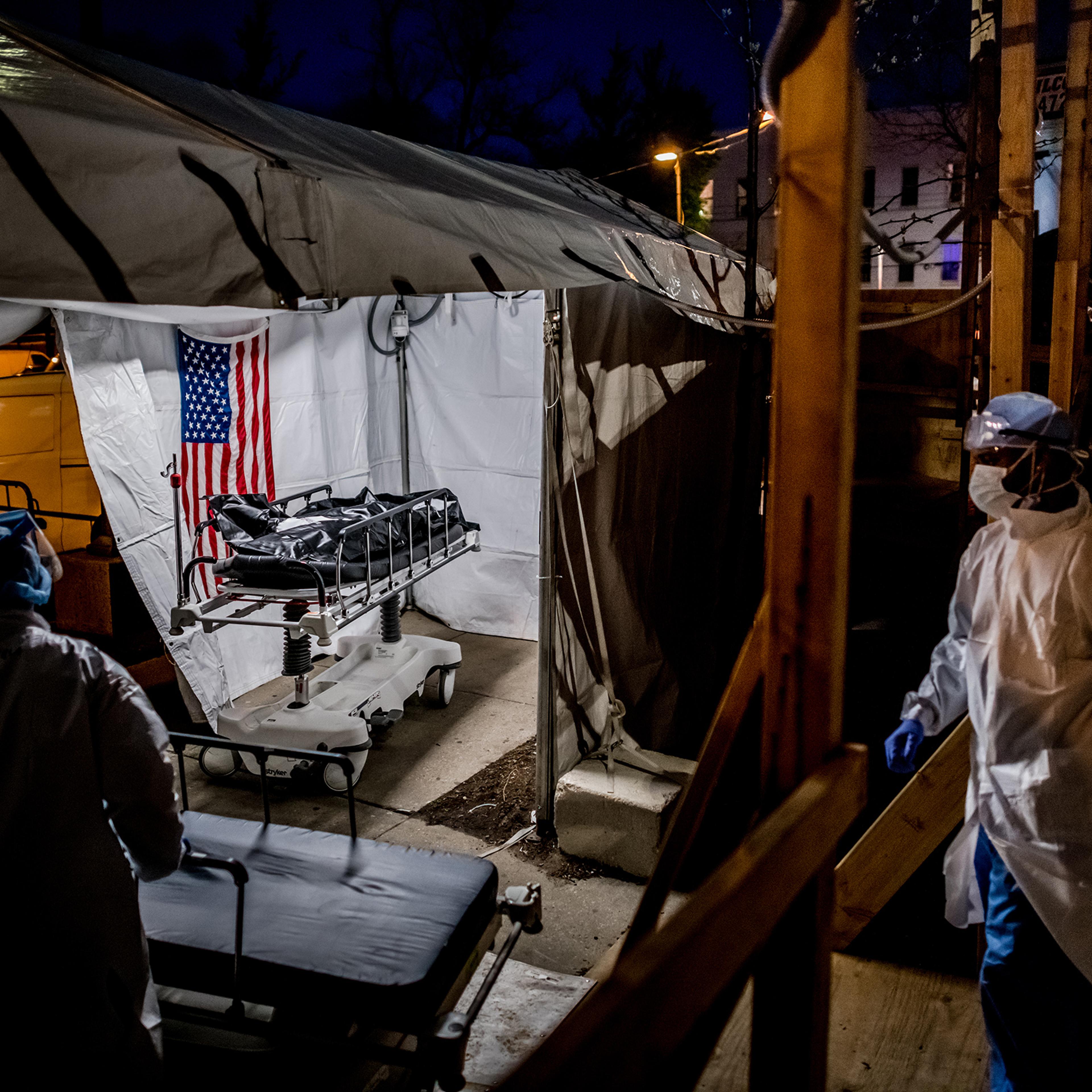 The transport team moves the body bags of deceased COVID-19 patients from the overflowing morgue of Brooklyn's Wyckoff Heights Medical Center into the improvised morgue set up outside on April 27. Three refrigerated semitrailers, capable of holding more