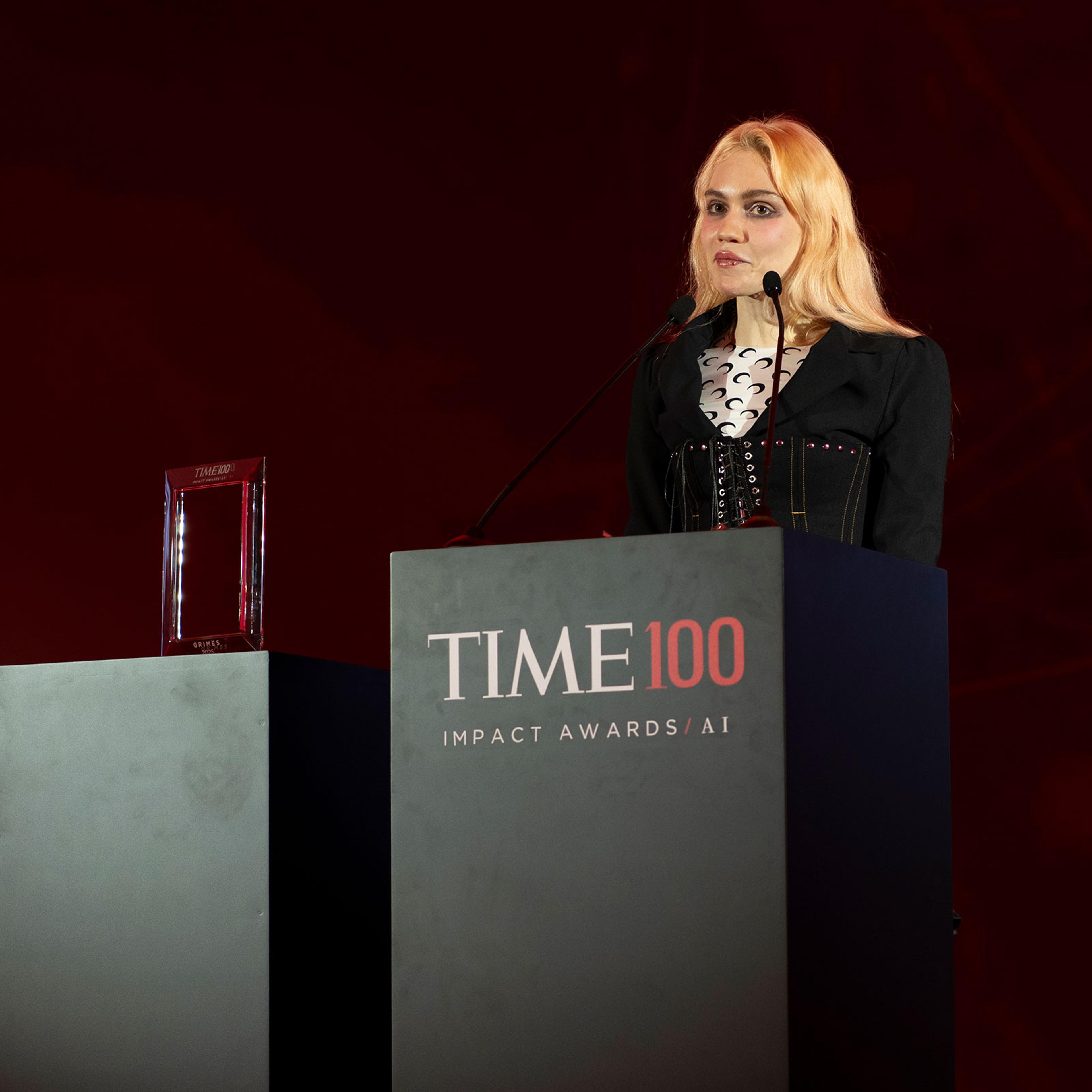 Grimes speaks on stage at the TIME100 AI Impact Awards Dubai, on Feb. 11, 2025.