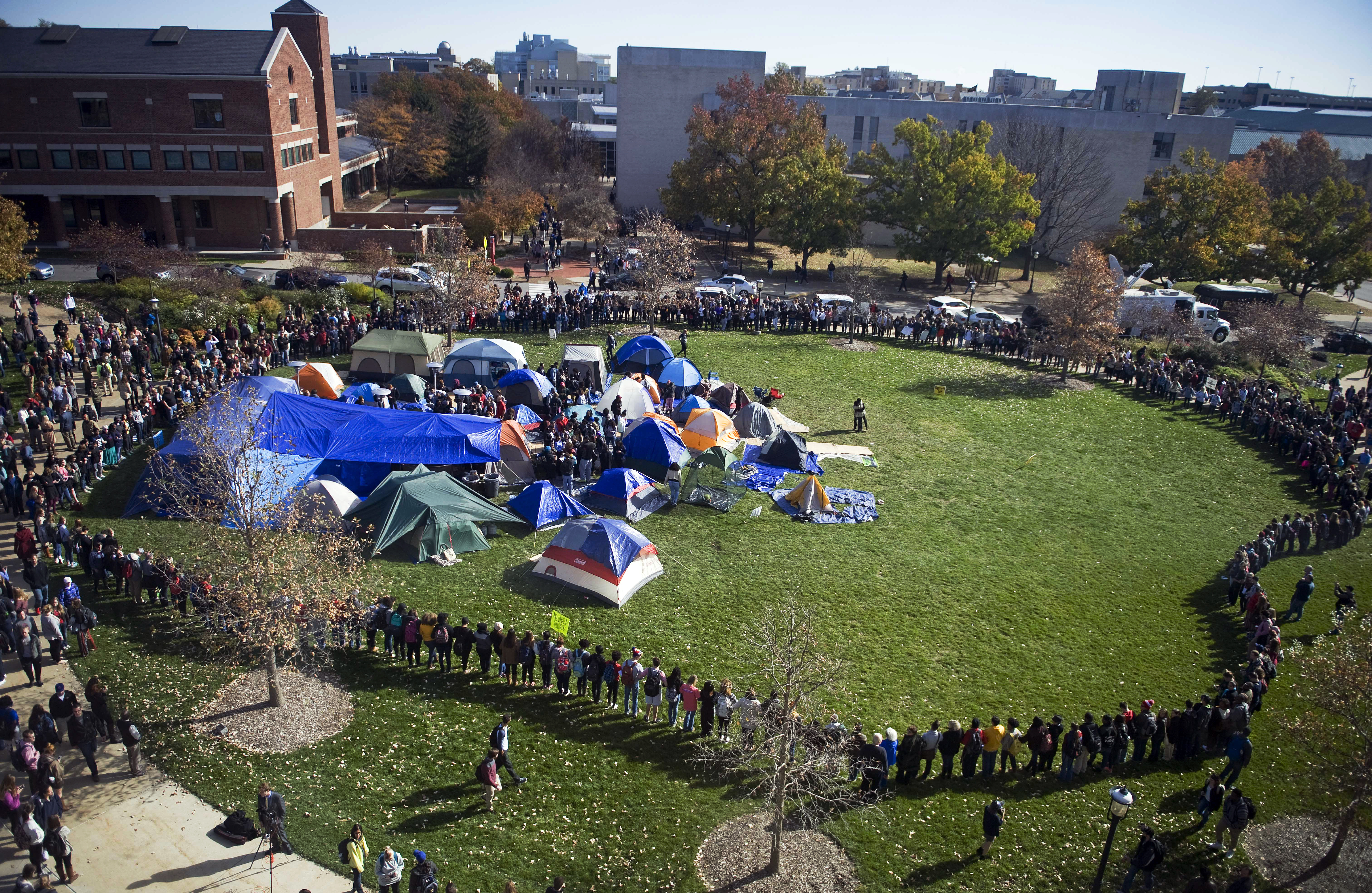Supporters of the student protest group Concerned Student 1950 lock arms and form a perimeter following the announcement of the resignation of University of Missouri President Timothy Wolfe, on campus in Columbia.
