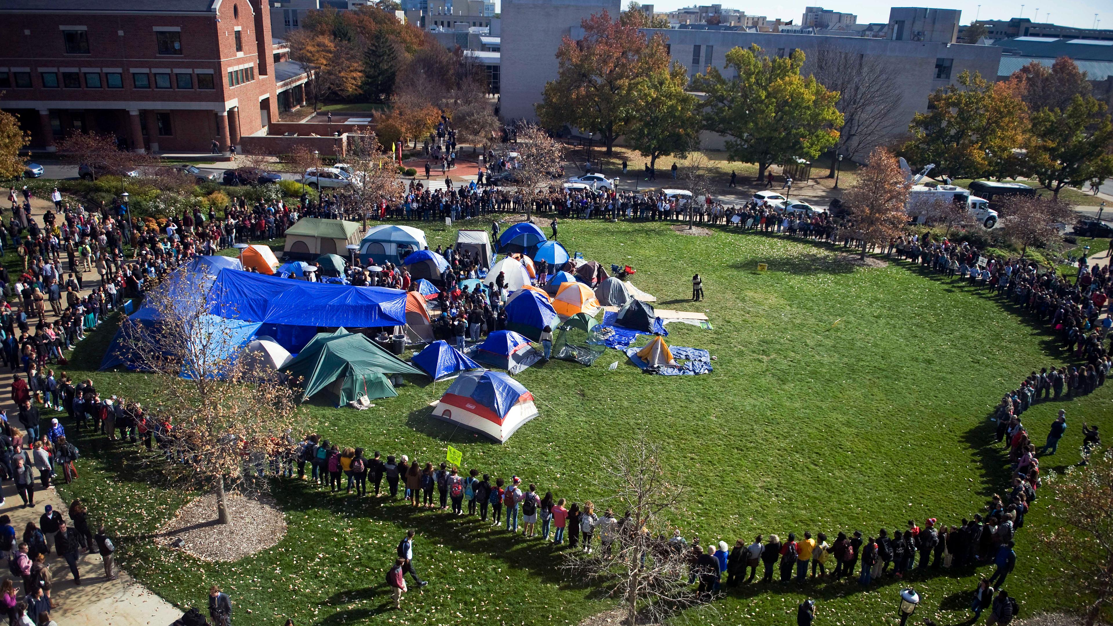 Supporters of the student protest group Concerned Student 1950 lock arms and form a perimeter following the announcement of the resignation of University of Missouri President Timothy Wolfe, on campus in Columbia.